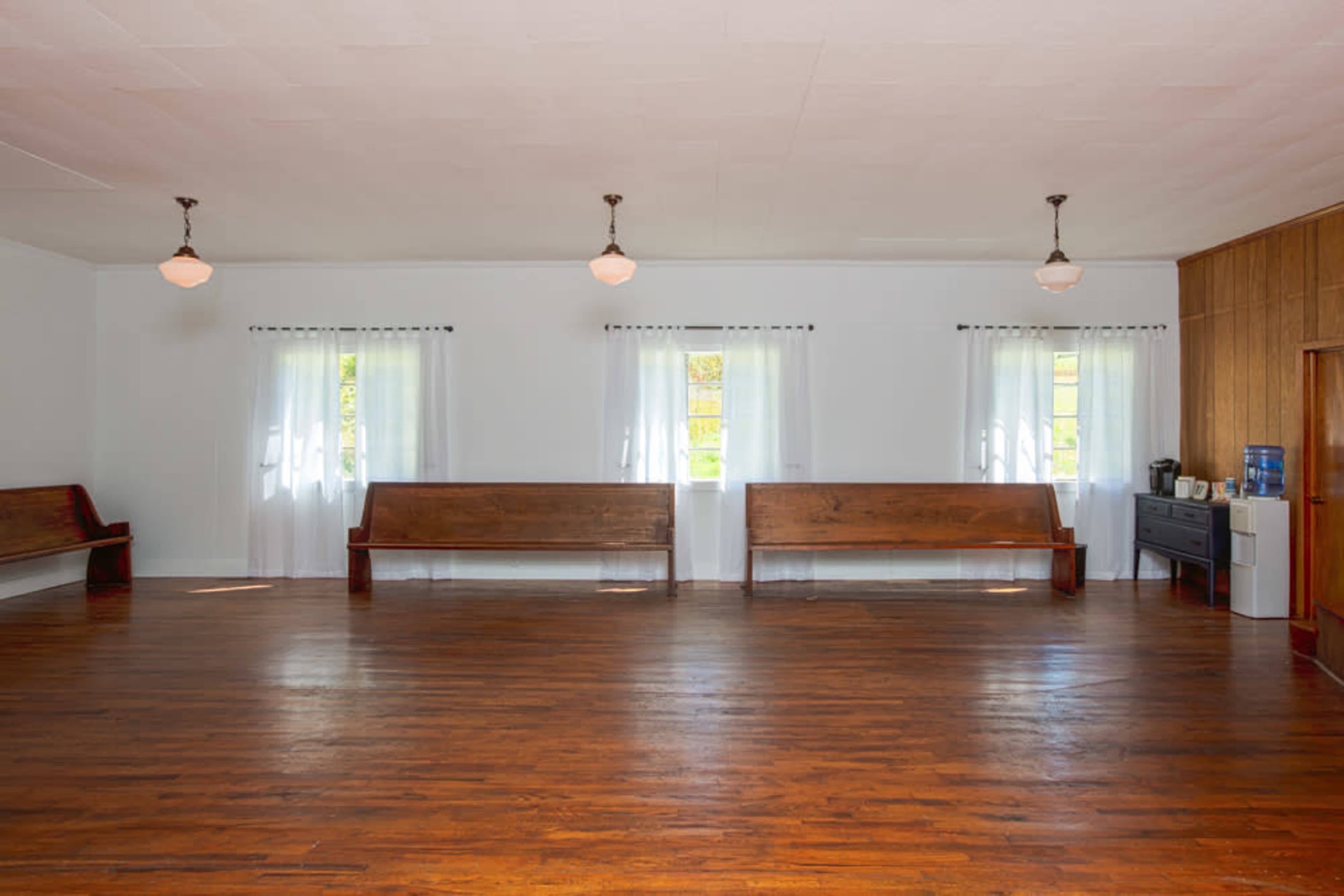 The Studio at Valle View ~ simple old church building with lots of natural light, a stage and pews, rural area Image in , Banner Elk, NC