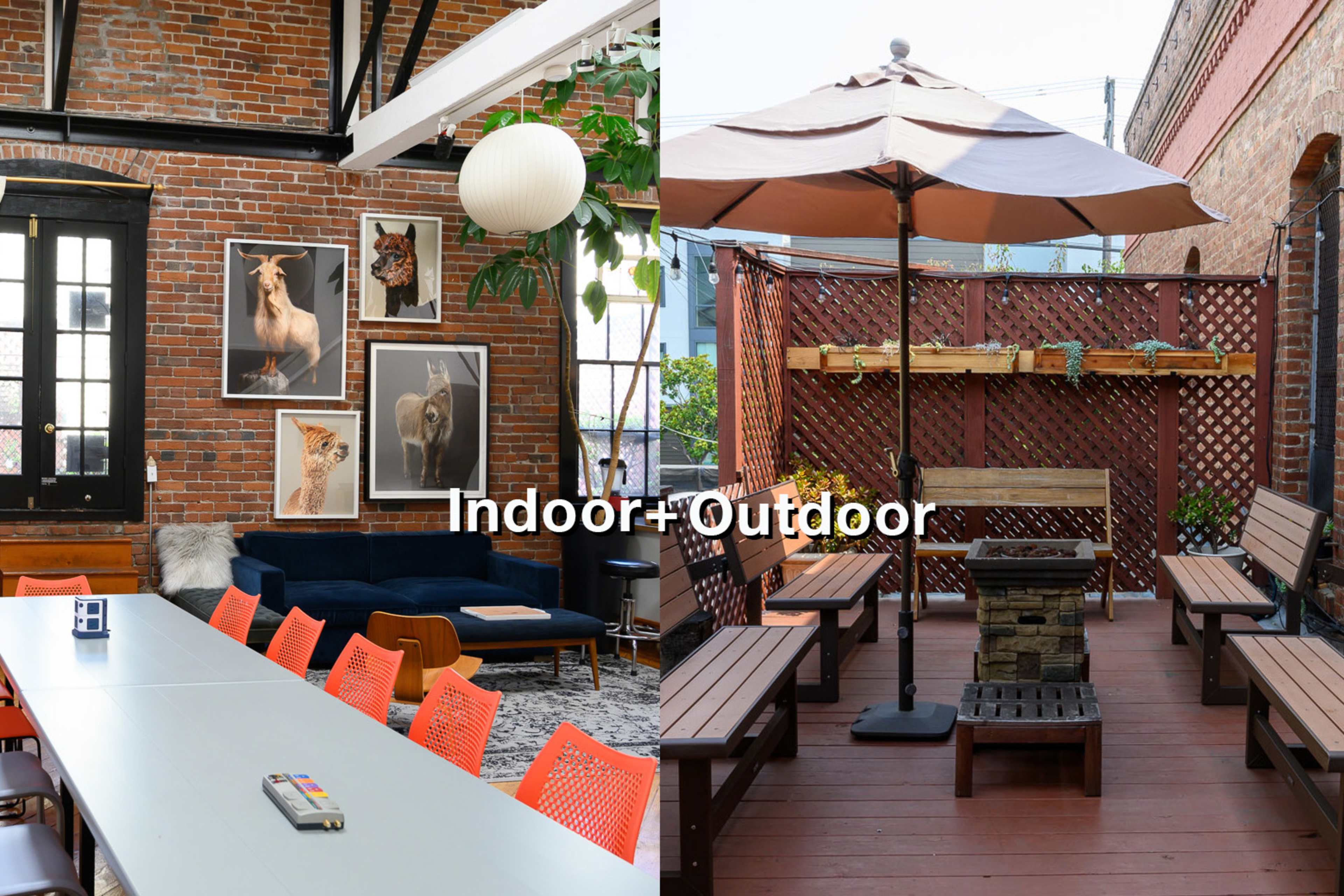 A large room with a long table and colorful chairs on one side, and an outdoor patio area with wooden seating and a fire pit on the other.