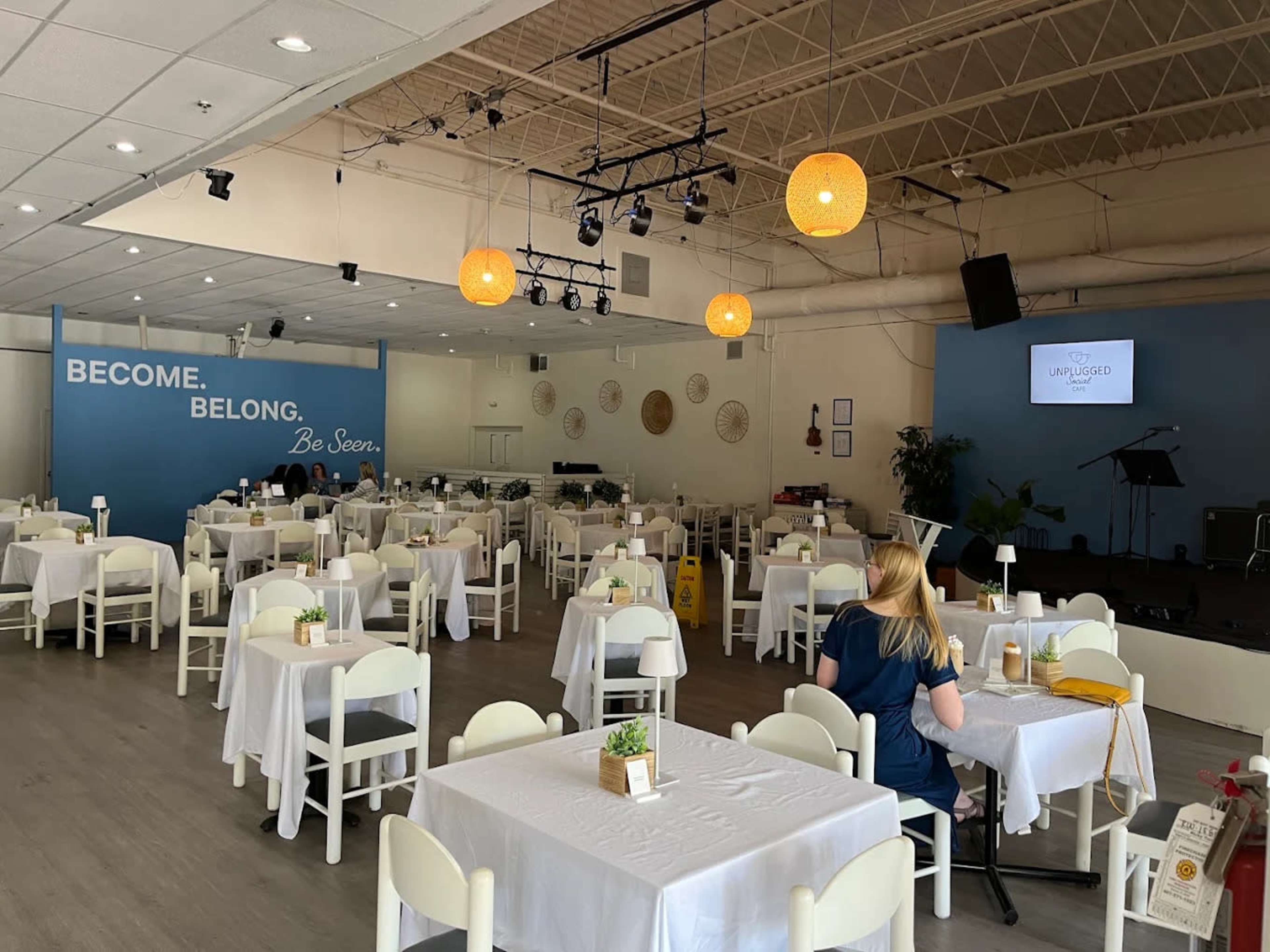 Clean, Open, White Table cloth, with Stage and Bar. Image in , Orlando, FL