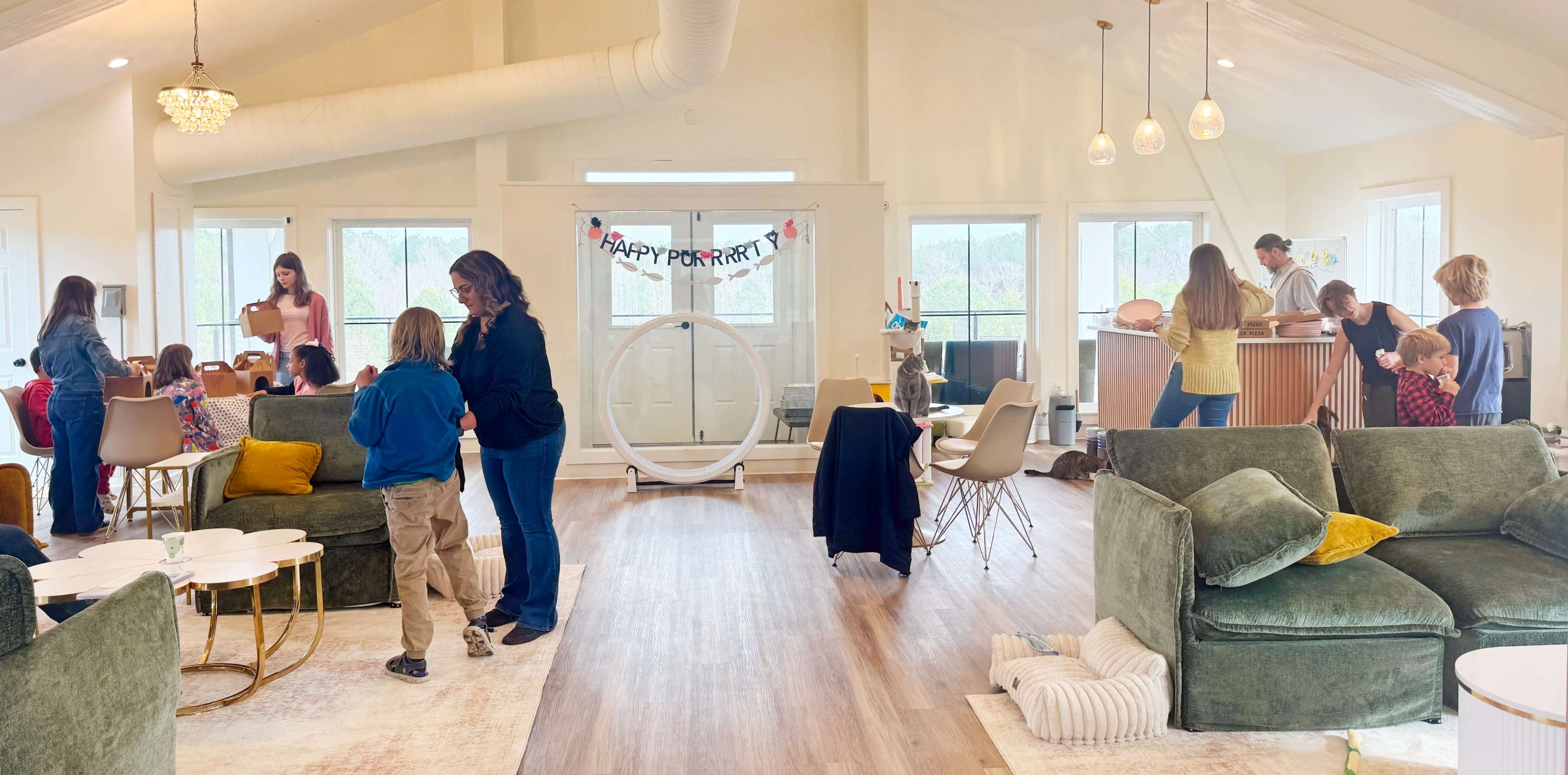 A spacious indoor party scene features adults and children engaging in various activities while festive decorations are visible.