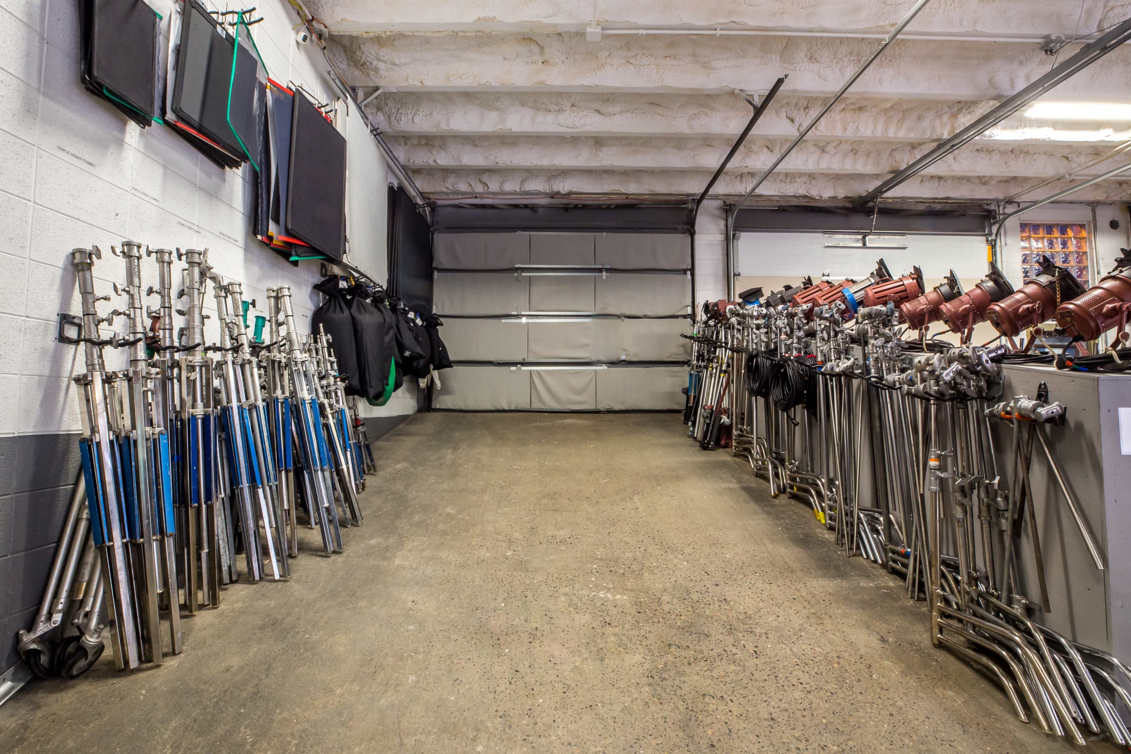 A spacious garage or workshop with metal stands and equipment neatly arranged along the walls.