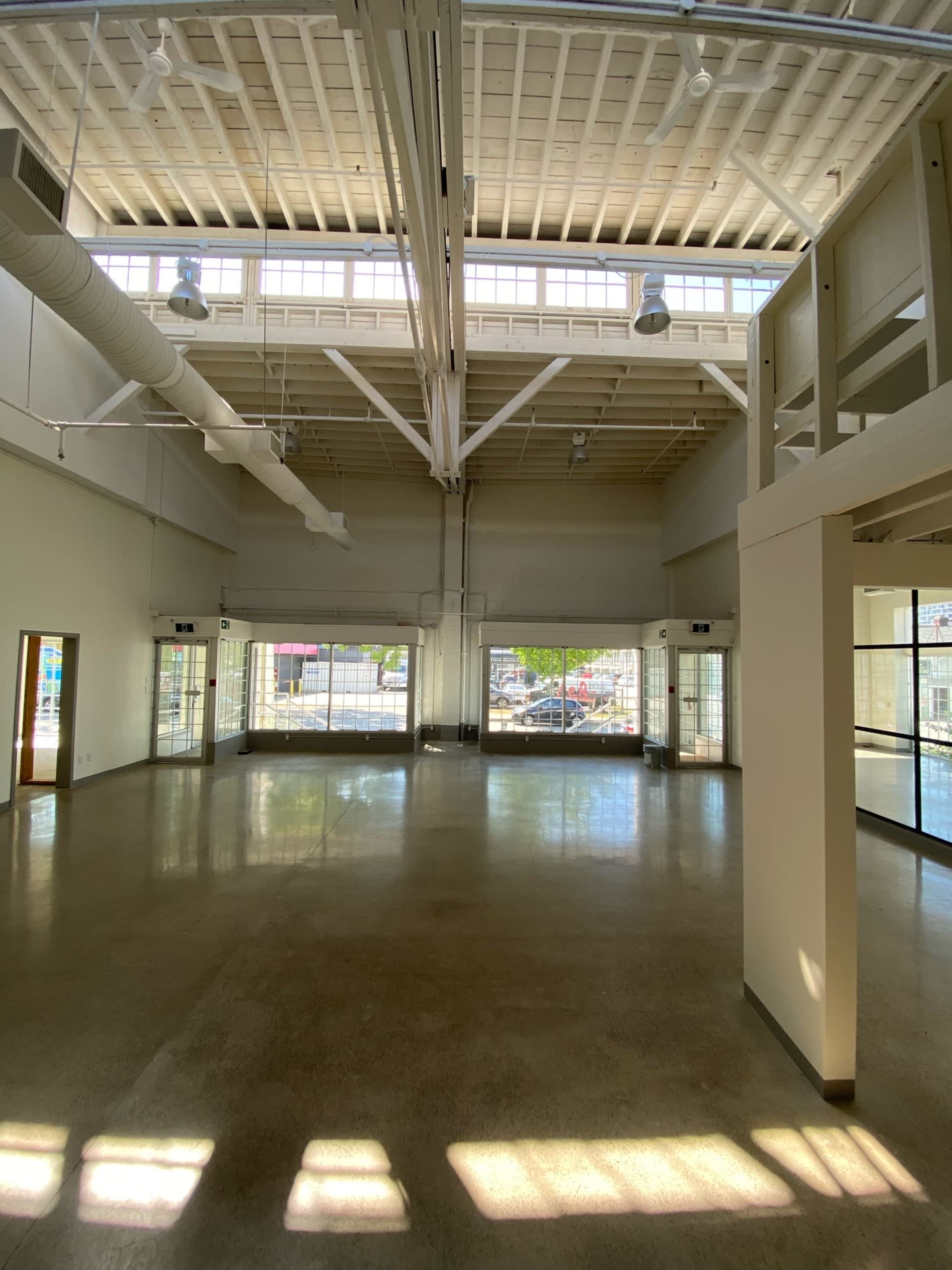 A spacious, brightly lit interior space with large windows and a high ceiling.