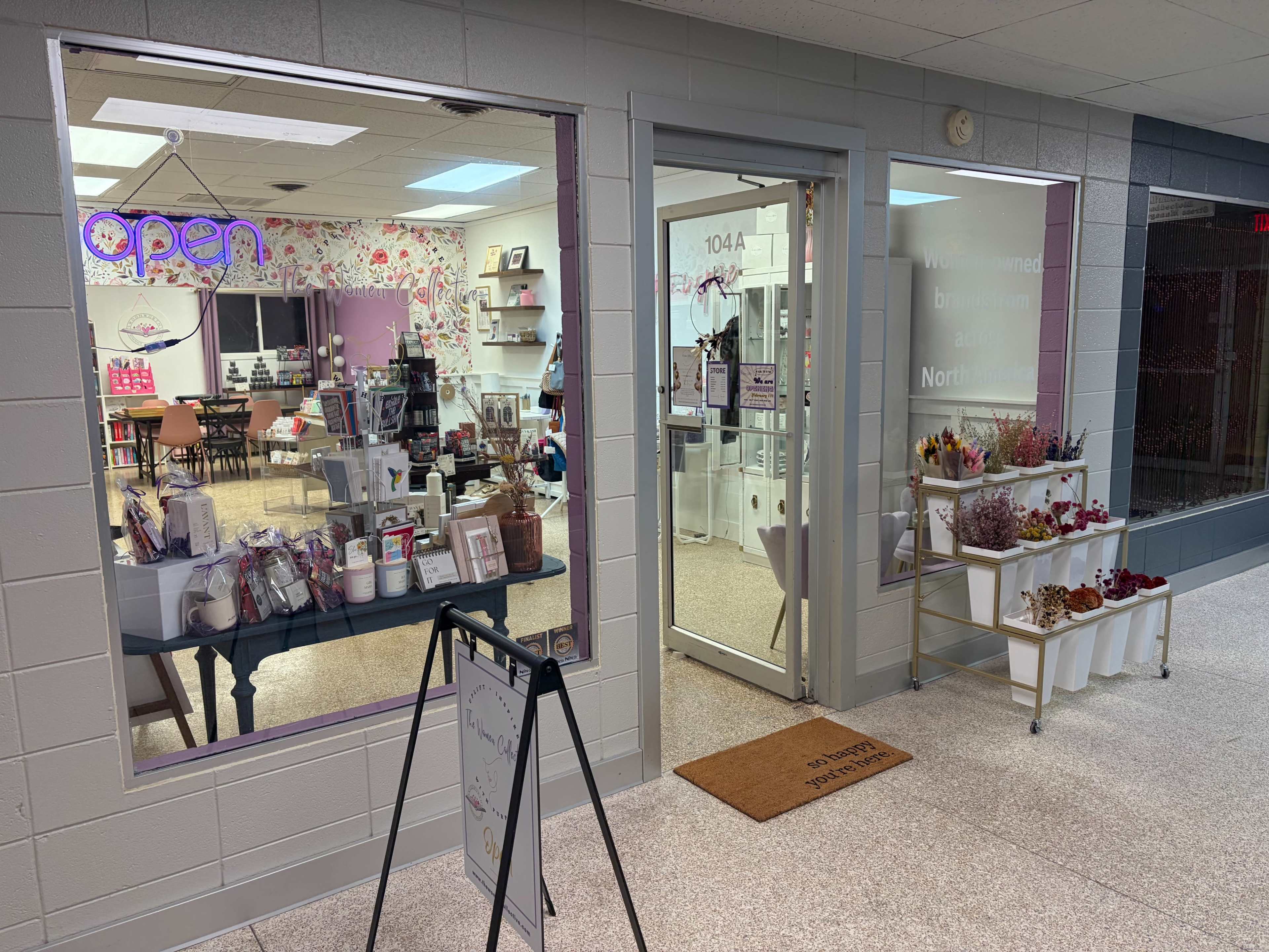 The image shows a storefront with a sign that reads "open," displaying a variety of gifts and decorations inside.