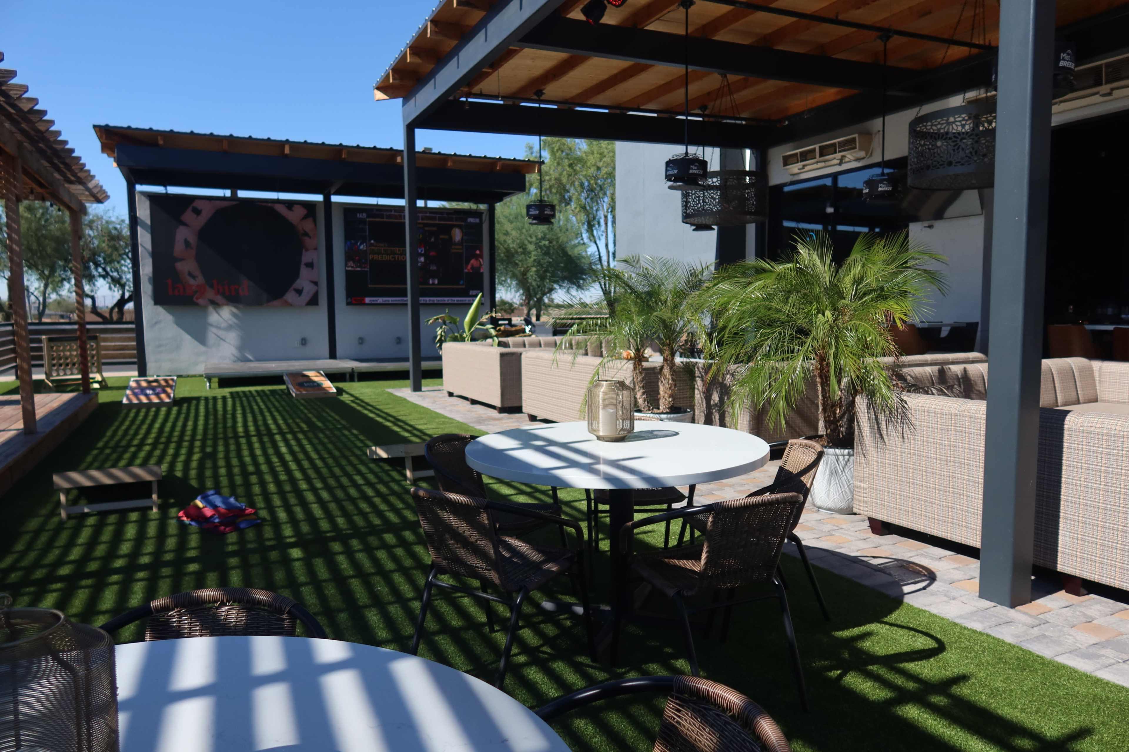 Modern Outdoor Lounge with Couches and Lush Plants Image in Park West, Peoria, AZ