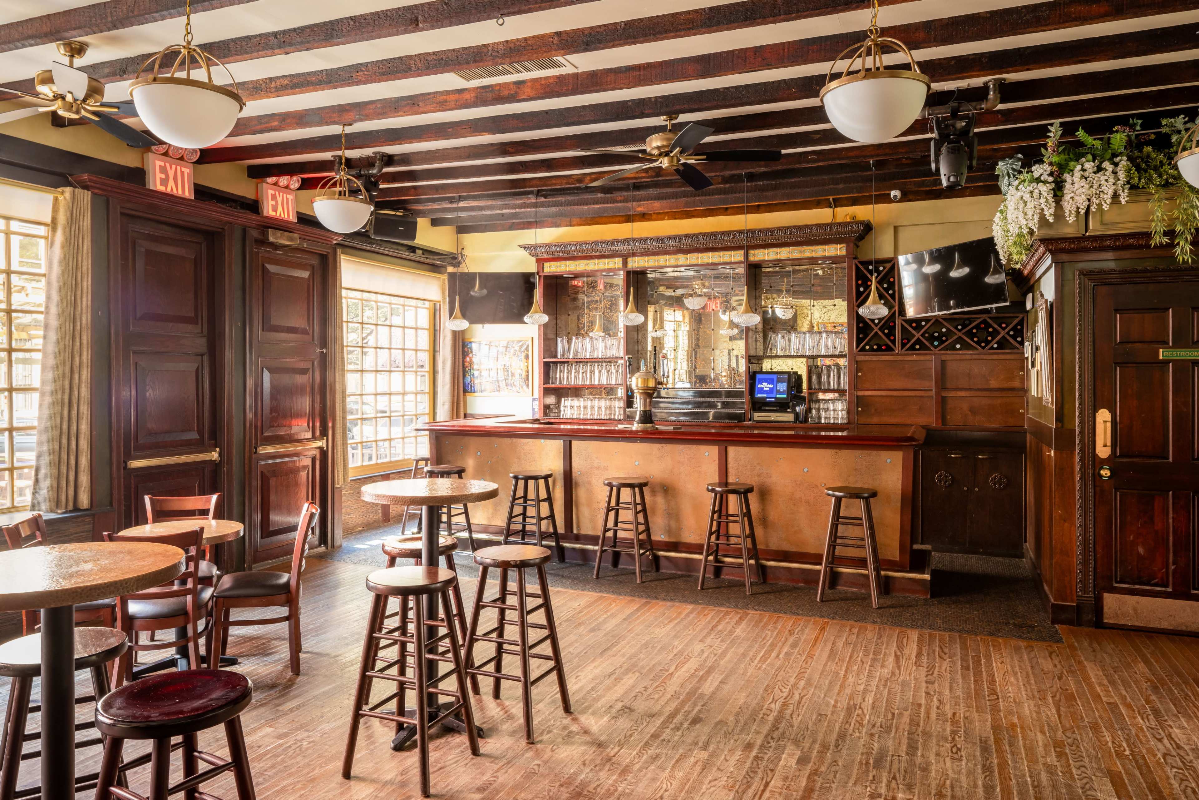 The East Wing - a mid-century bar set flooded with natural light Image in Lenox Hill, New York City, NY