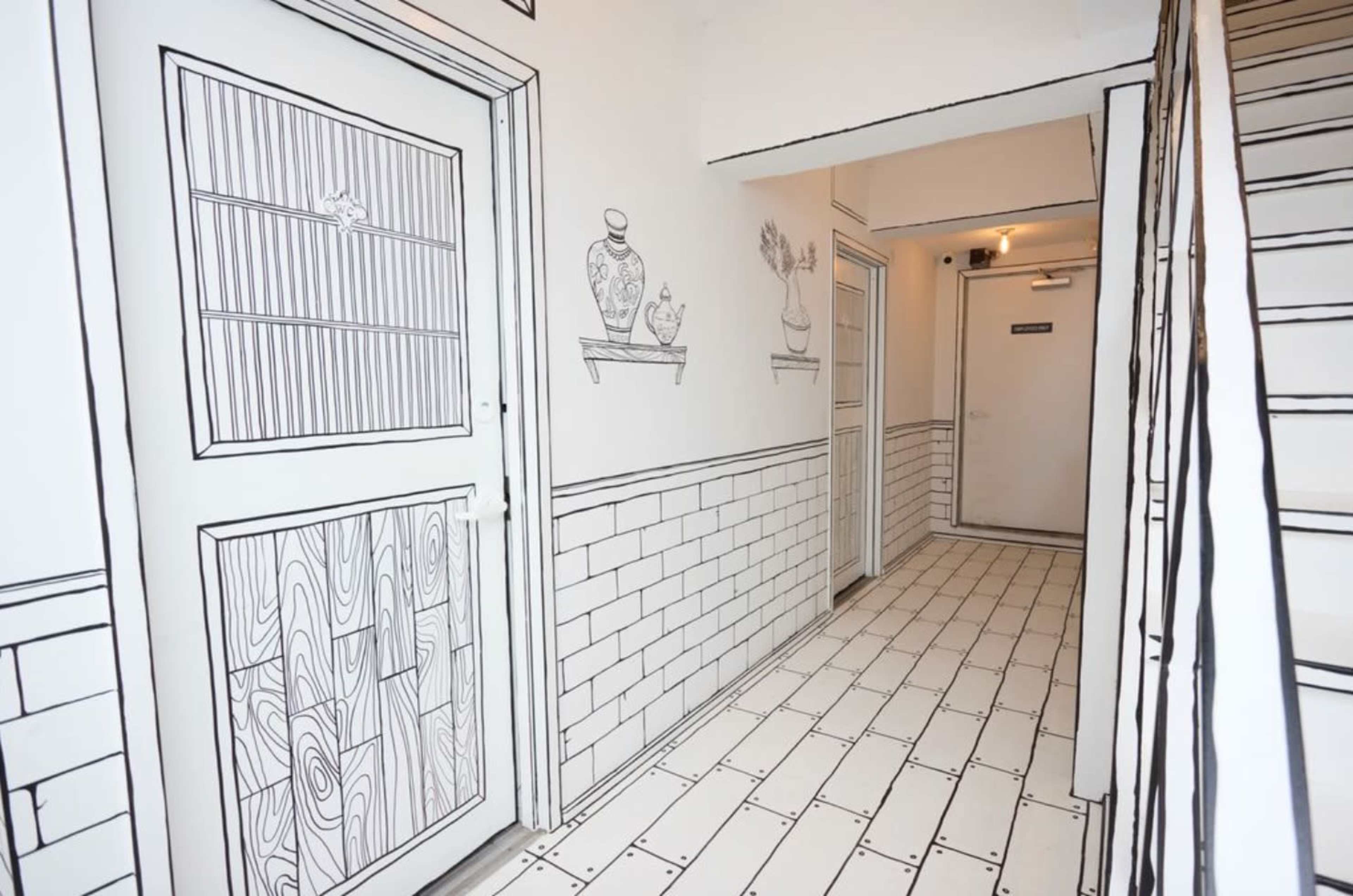 The image shows a hallway with walls and doors illustrated in a black-and-white line drawing style, creating a three-dimensional illusion.
