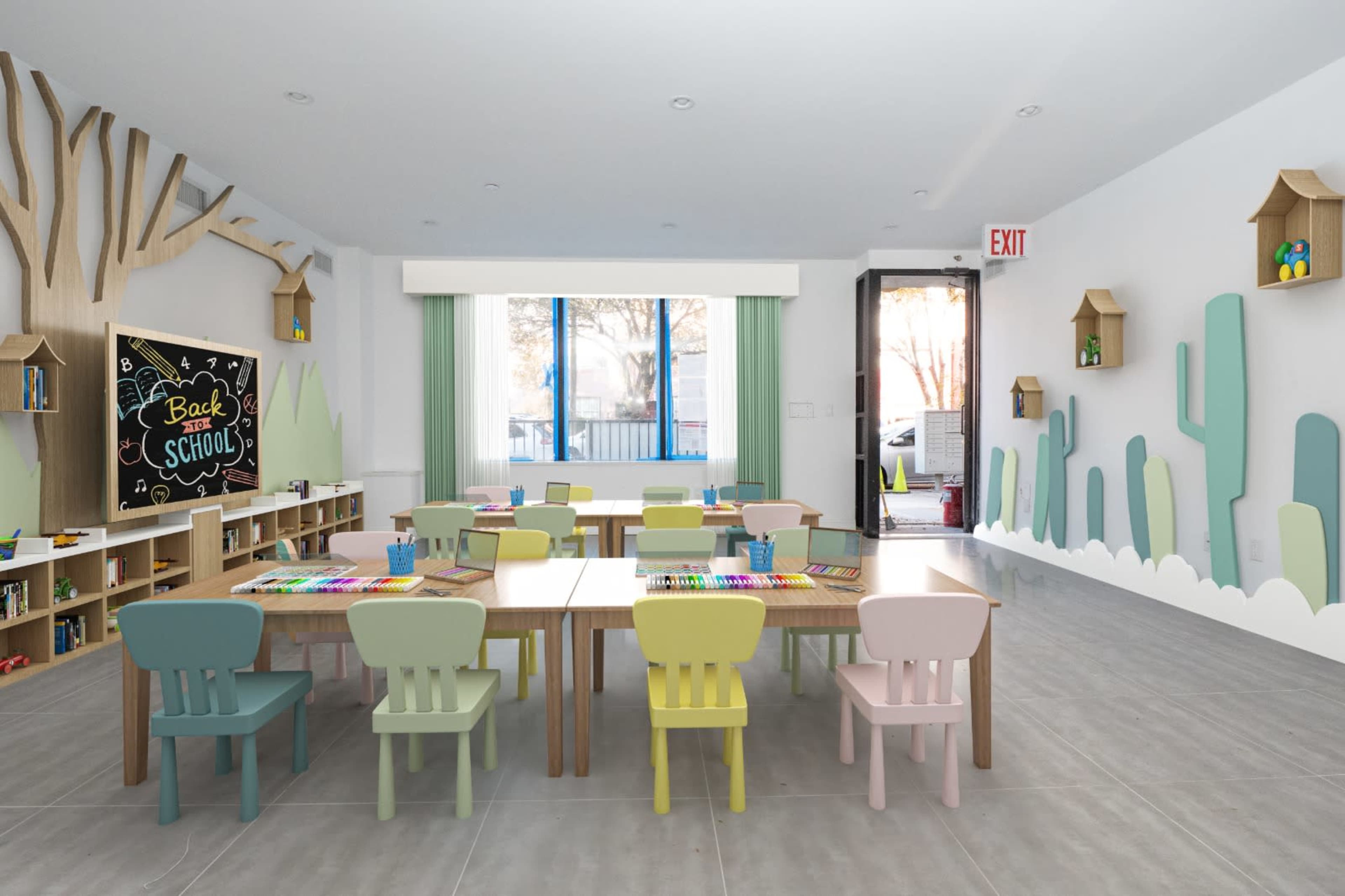 A brightly lit classroom with several tables and chairs in soft pastel colors, a chalkboard with "Back to School," and decorative elements like trees and cacti on the walls.