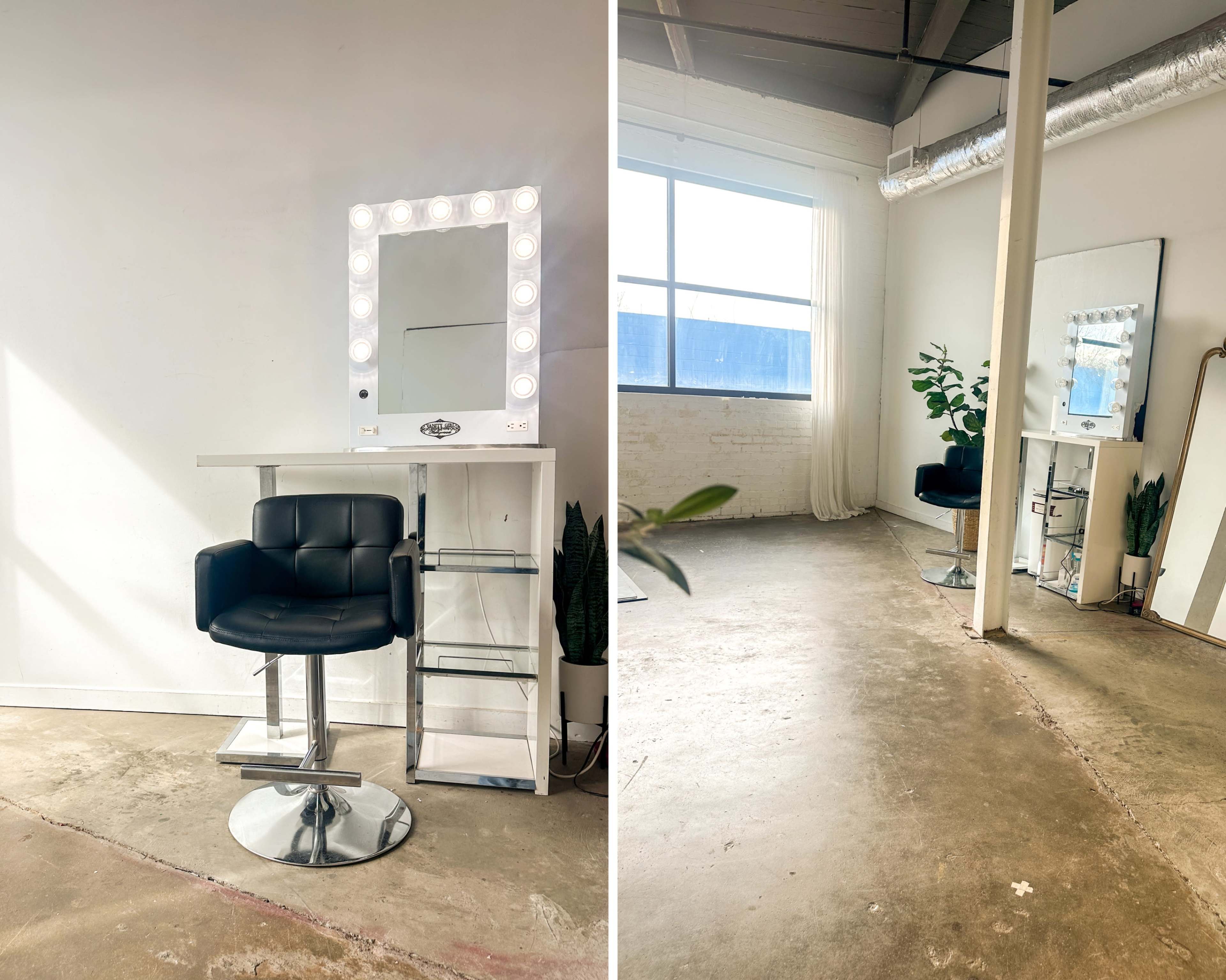 The image shows a minimalist hair salon with a black styling chair and a lighted mirror against a plain wall, alongside a large window and a potted plant.