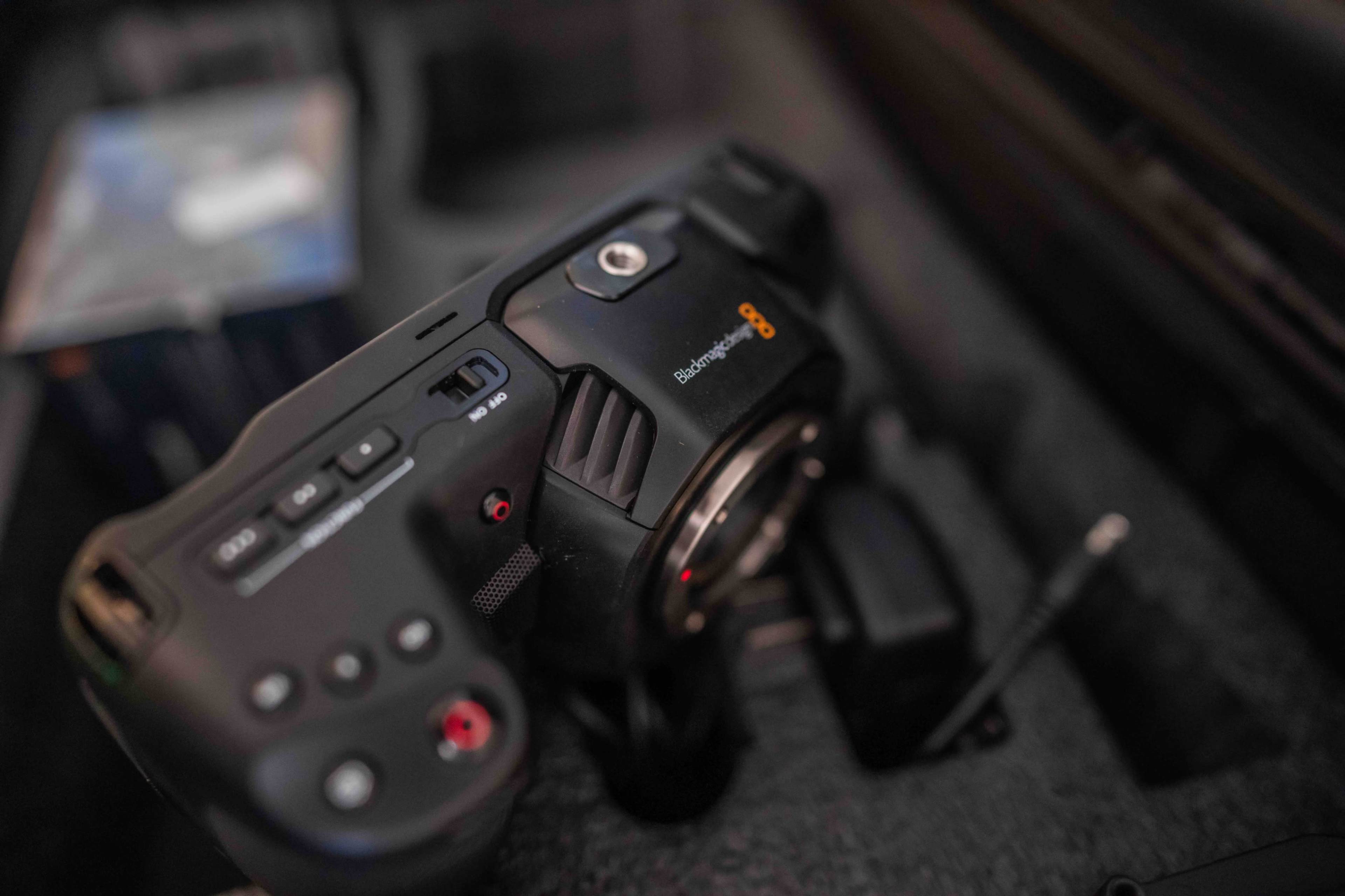 A Blackmagic Design camera is placed inside a padded case with other equipment visible in the background.
