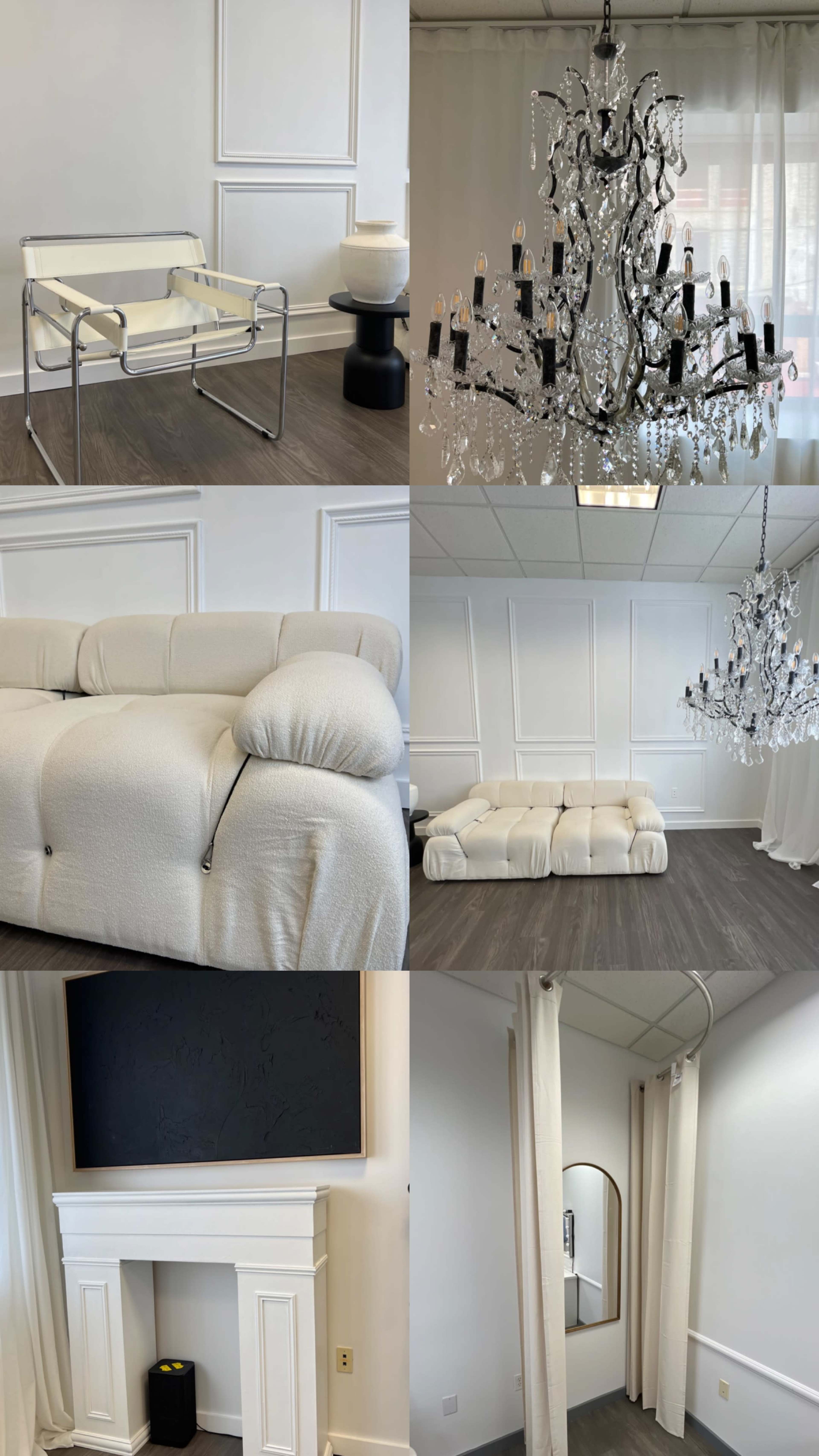 A modern interior with a white and neutral color palette, showcasing a minimalist seating area, two ornate chandeliers, a plush couch, and a white decorative fireplace.