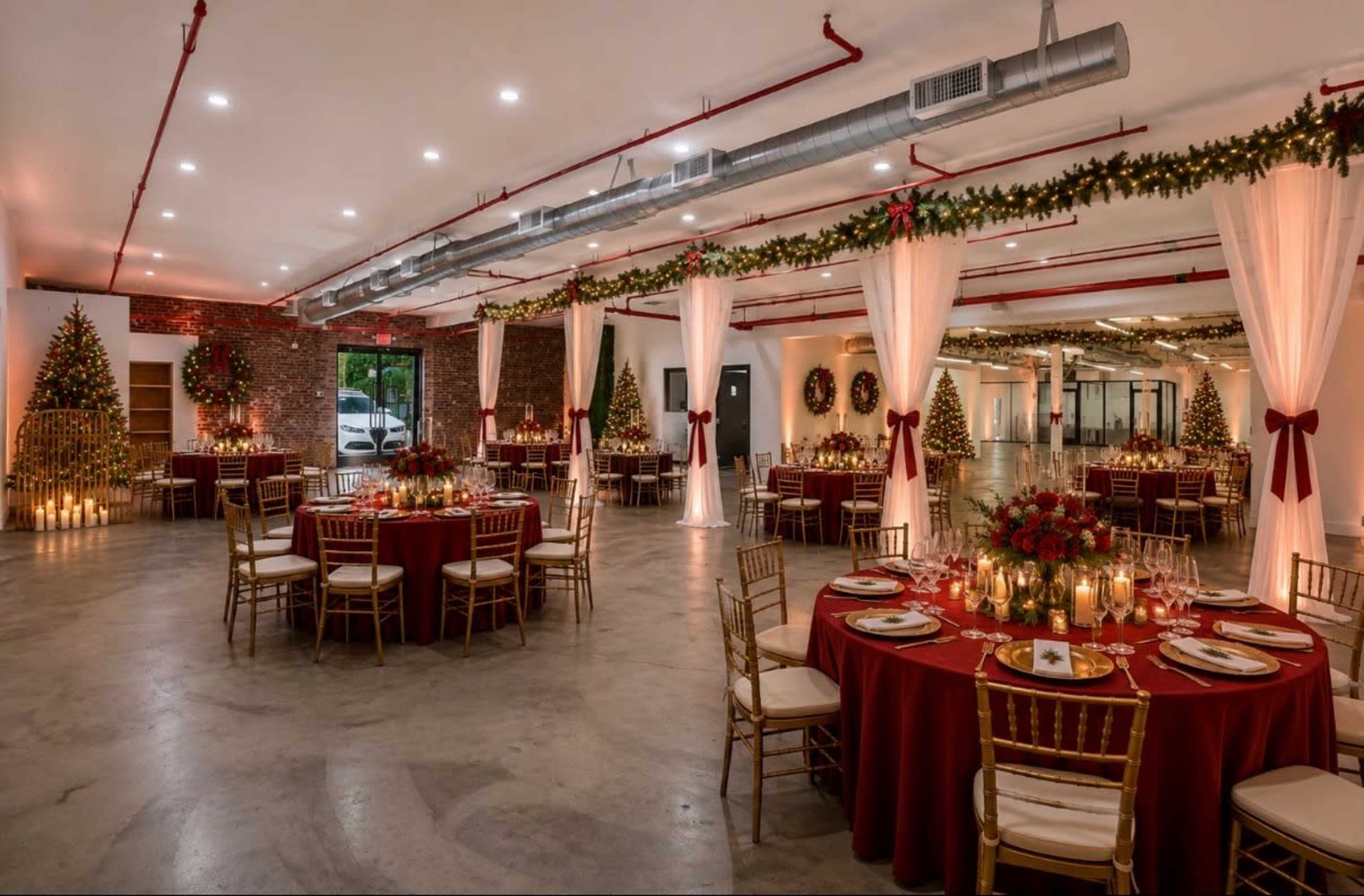 The image shows a festive banquet hall set up for a holiday event, featuring round tables with red tablecloths, gold chairs, and decorated with Christmas trees and wreaths.