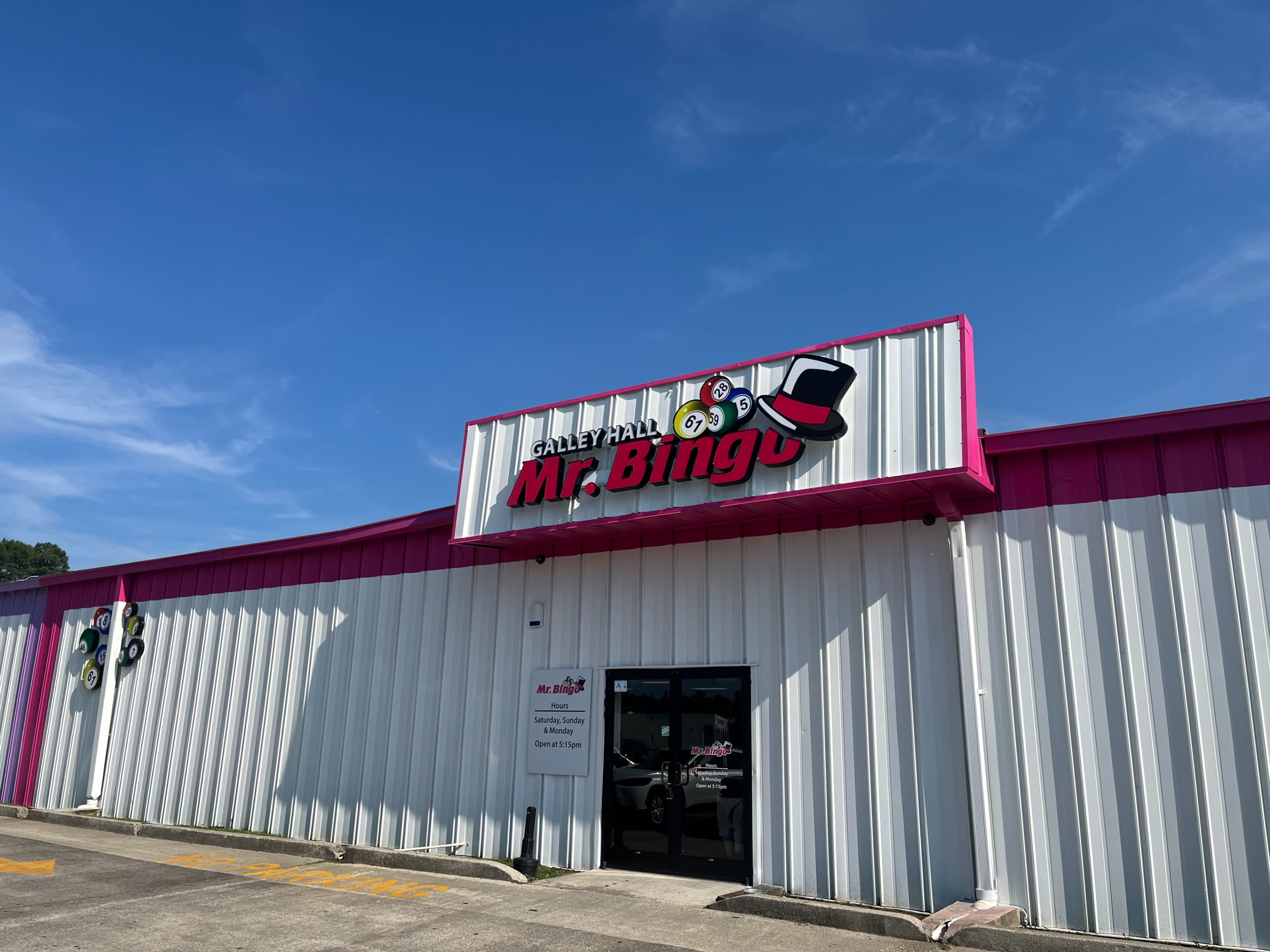 The exterior of a building features a sign for "Mr. Bingo" atop a pink and white facade.