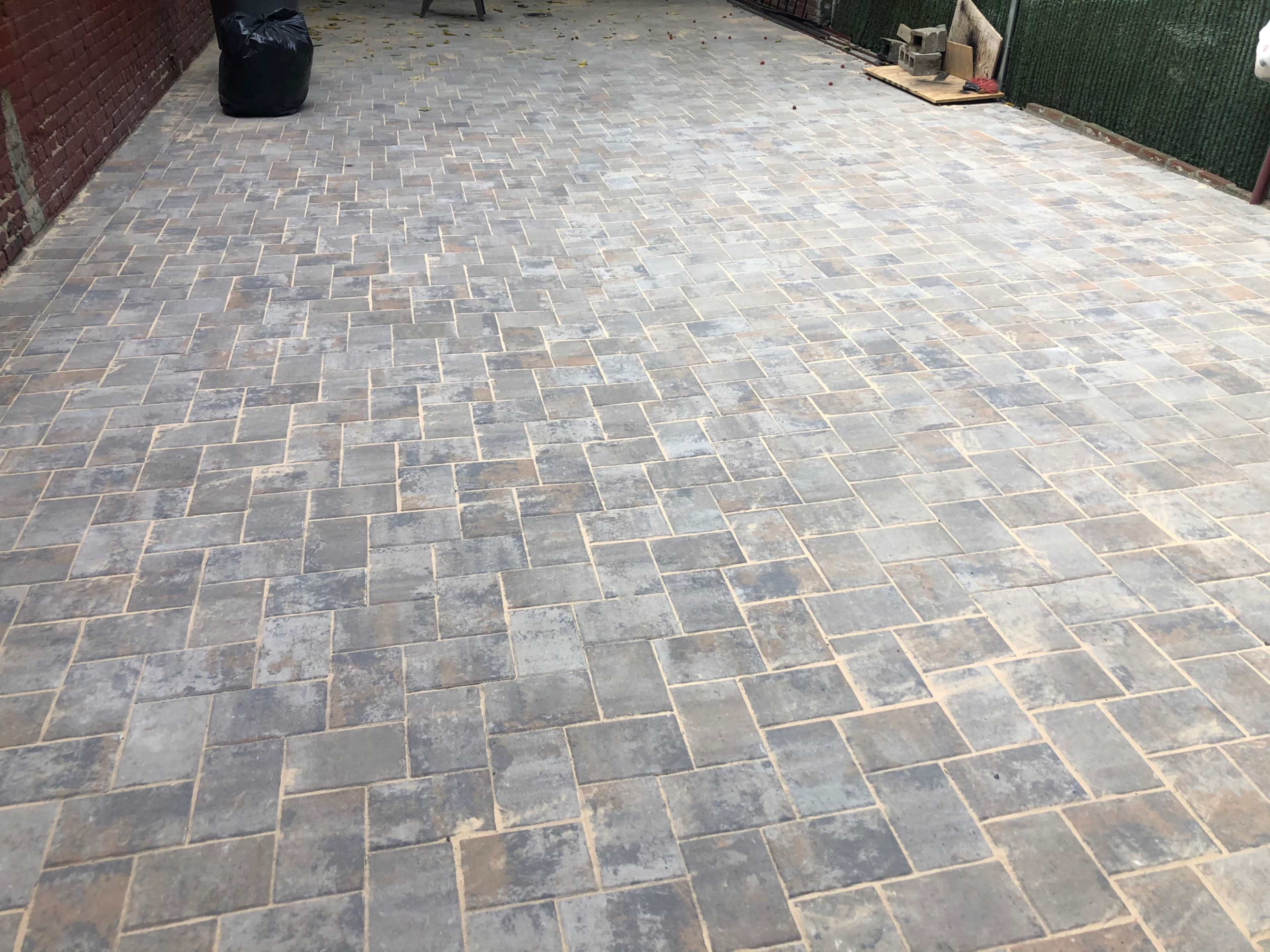 A paved outdoor area covered with rectangular stone tiles.