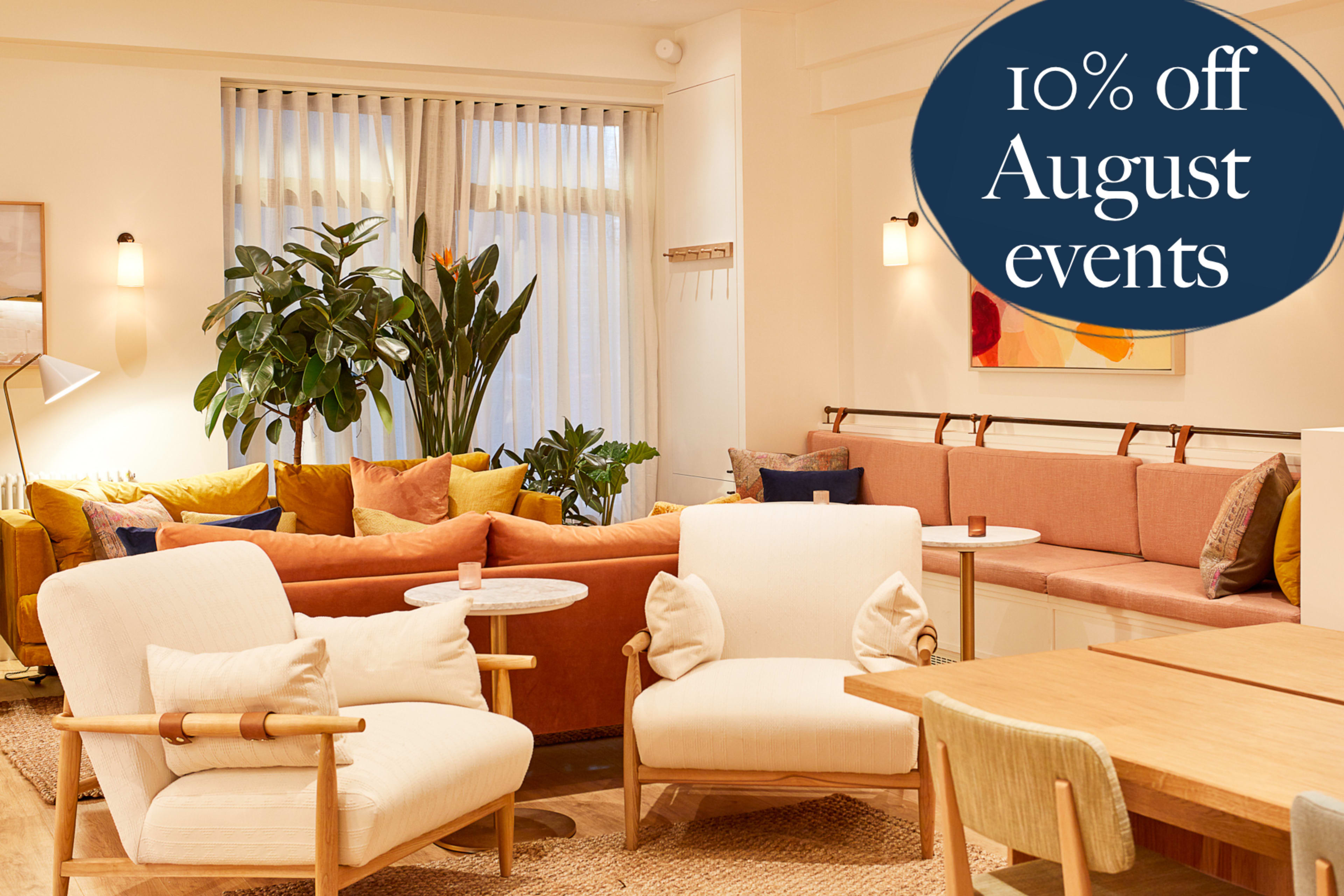 The image features a cozy indoor lounge area with a mix of comfortable seating, a large plant, and a promotional sign announcing a discount on events.