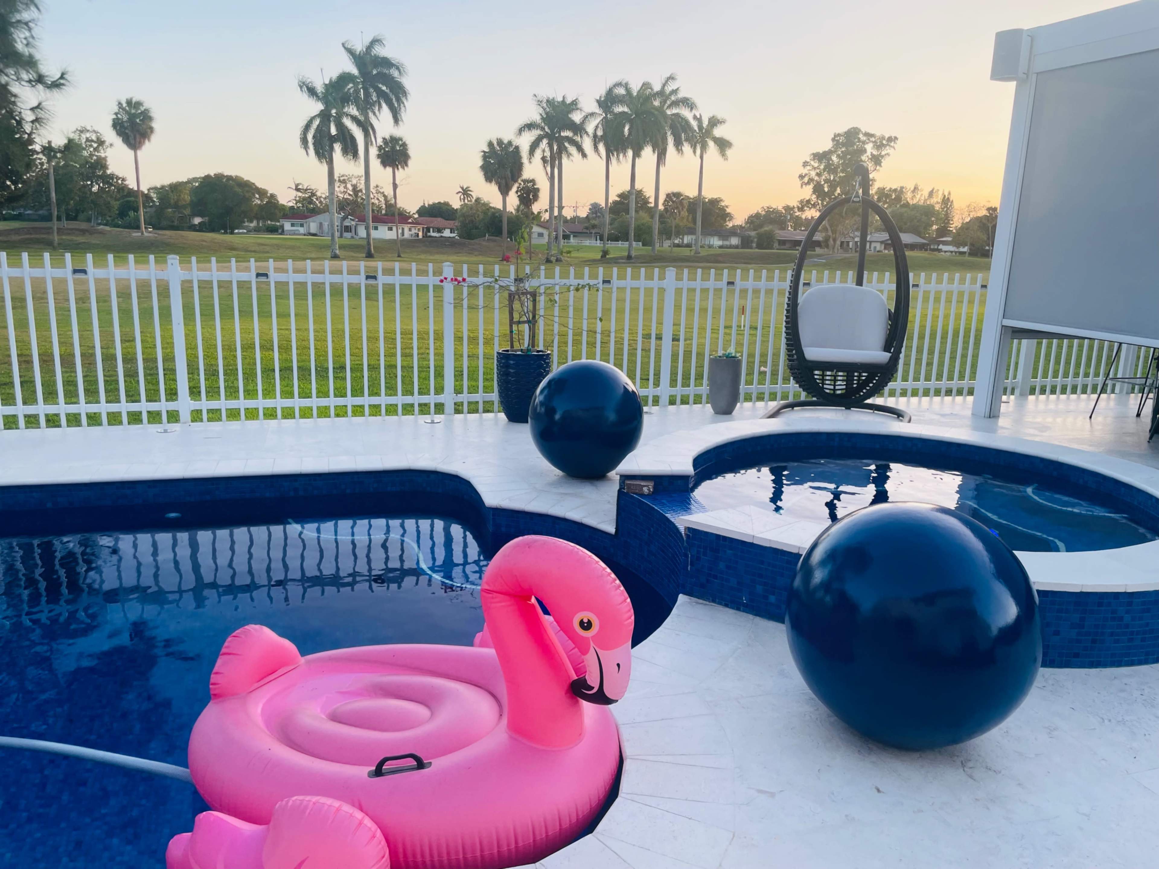 Country club, suburban, outdoor area with pool. Golf course view, roomy area with plenty of seating. Image in Country Club, Miami, FL