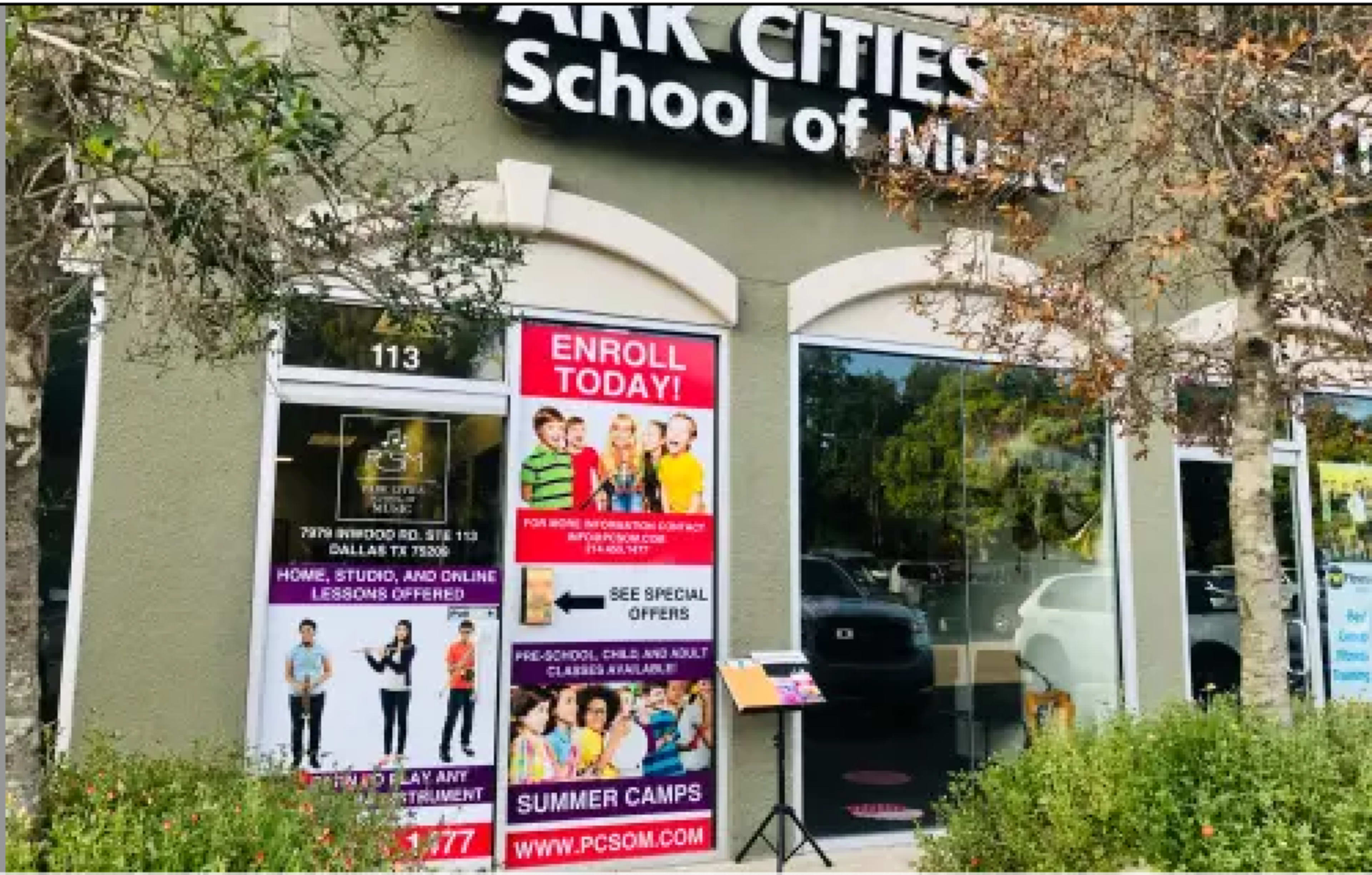 The image shows the exterior of Park Cities School of Music, featuring a large sign that advertises enrollment, special offers, and summer camps.