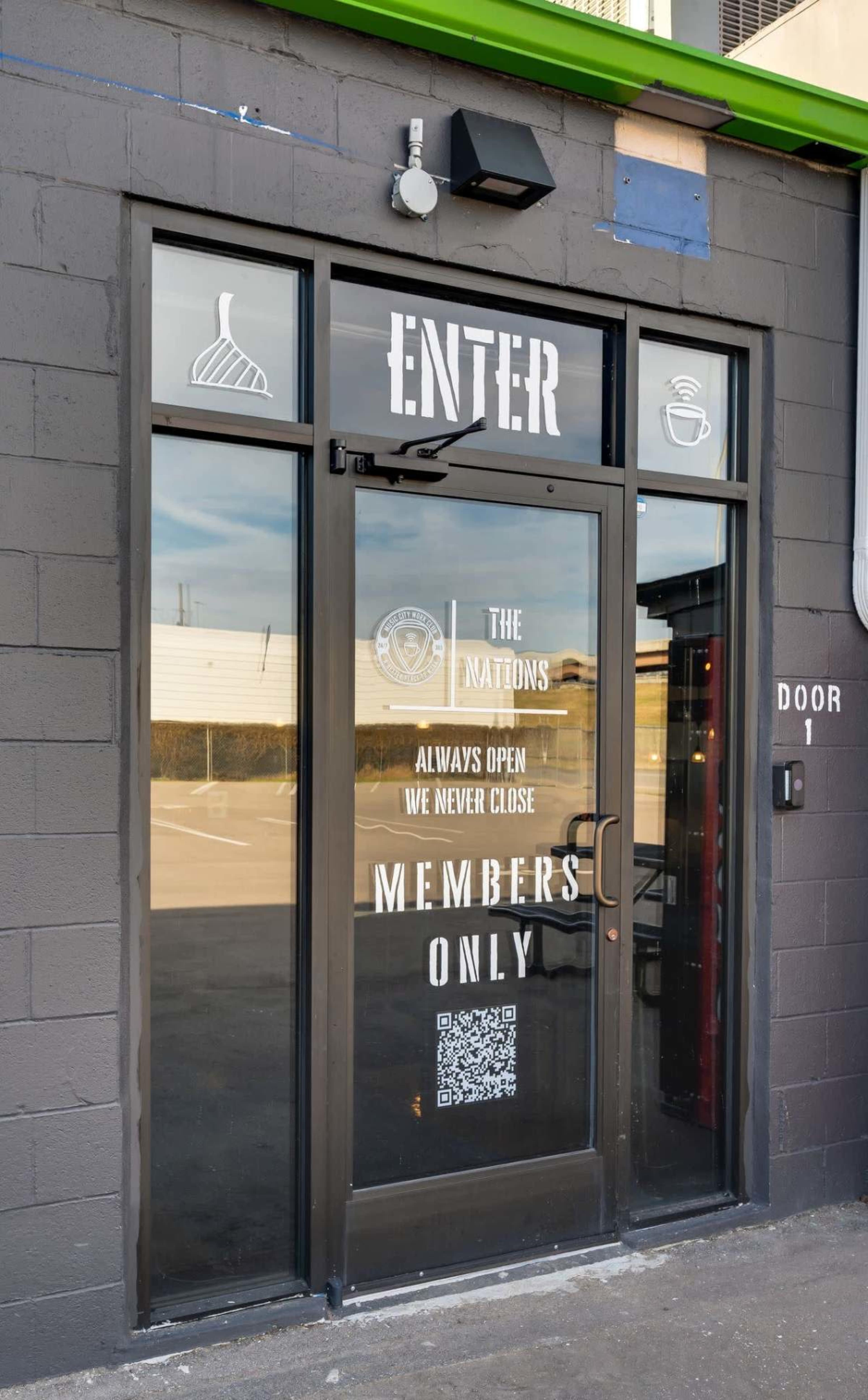 The entrance door features a sign that reads "ENTER" and indicates that the establishment is open 24/7 for members only.