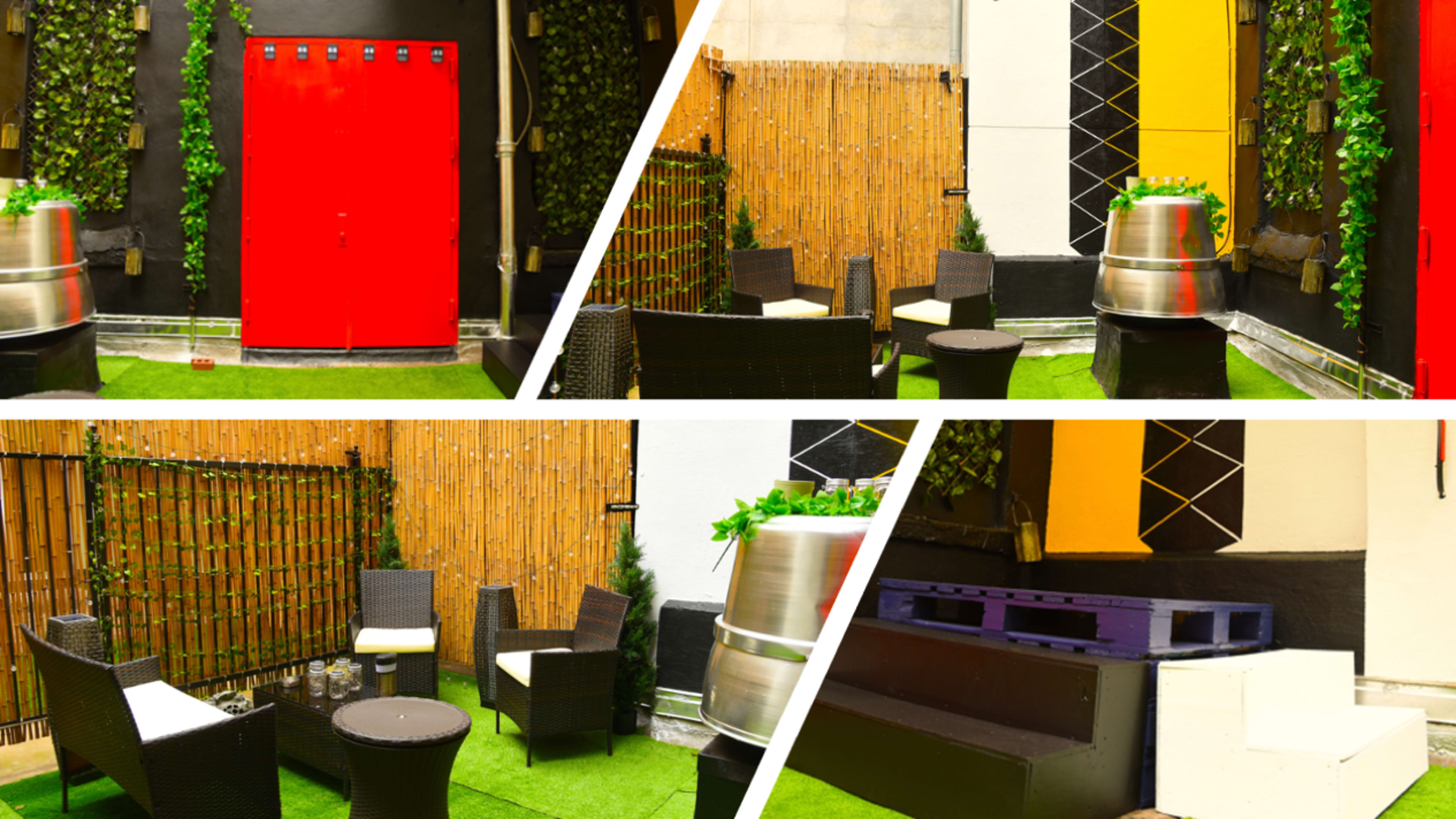 A small outdoor seating area with wicker furniture, wooden elements, and greenery against a backdrop of colorful walls.