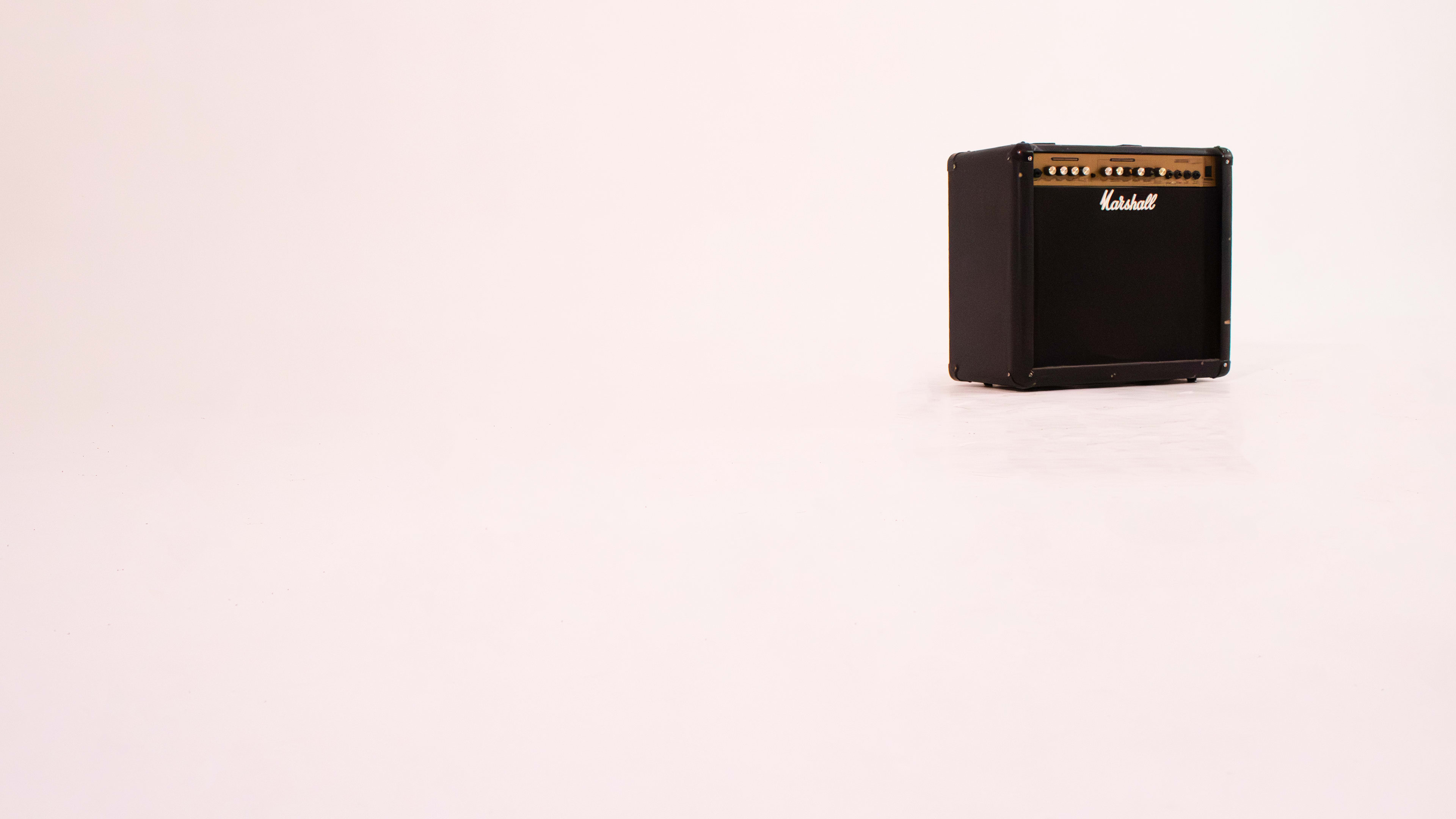 A black guitar amplifier is positioned on a white background.
