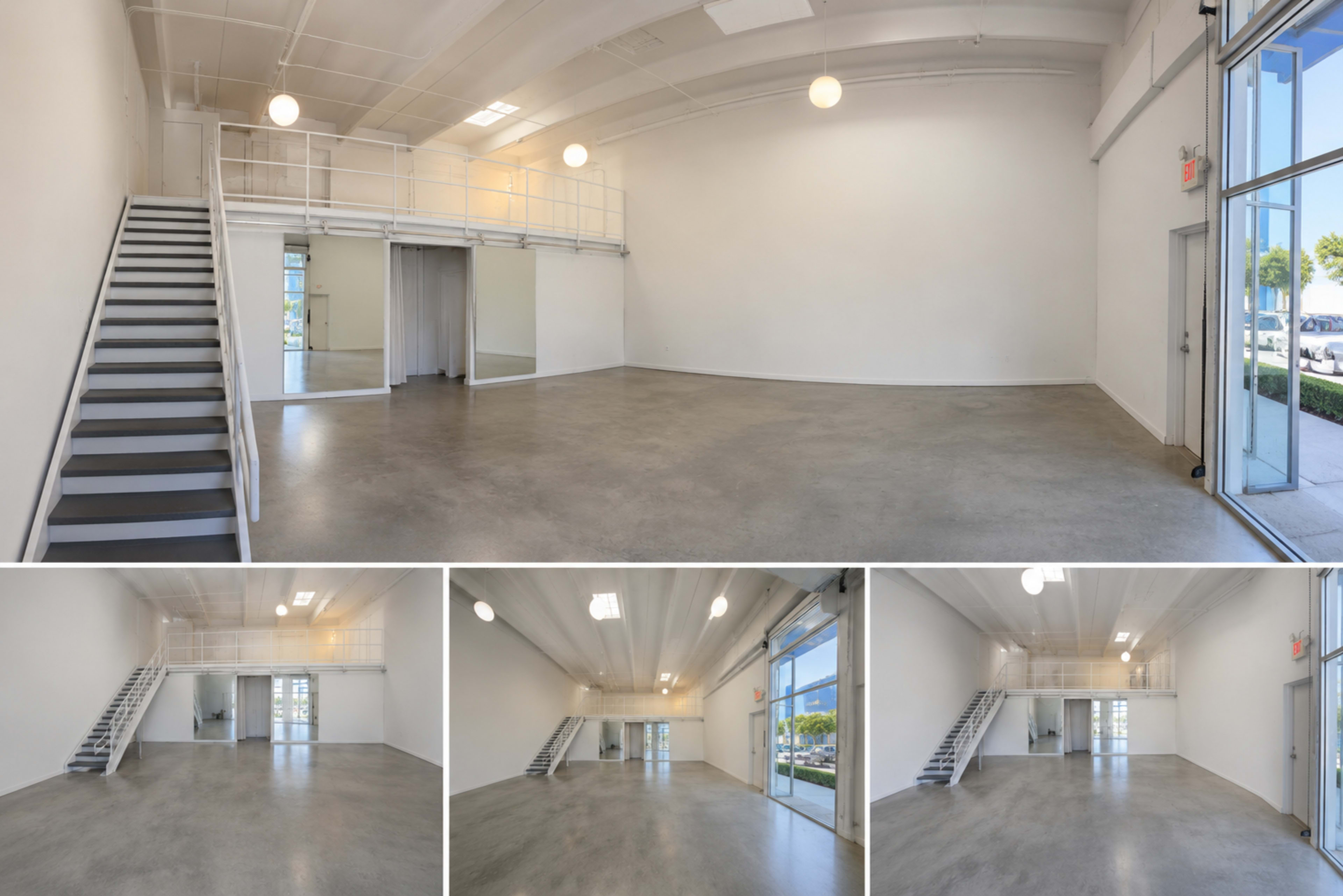The image shows an empty commercial space with a polished concrete floor, large windows, and a staircase leading to a second level.