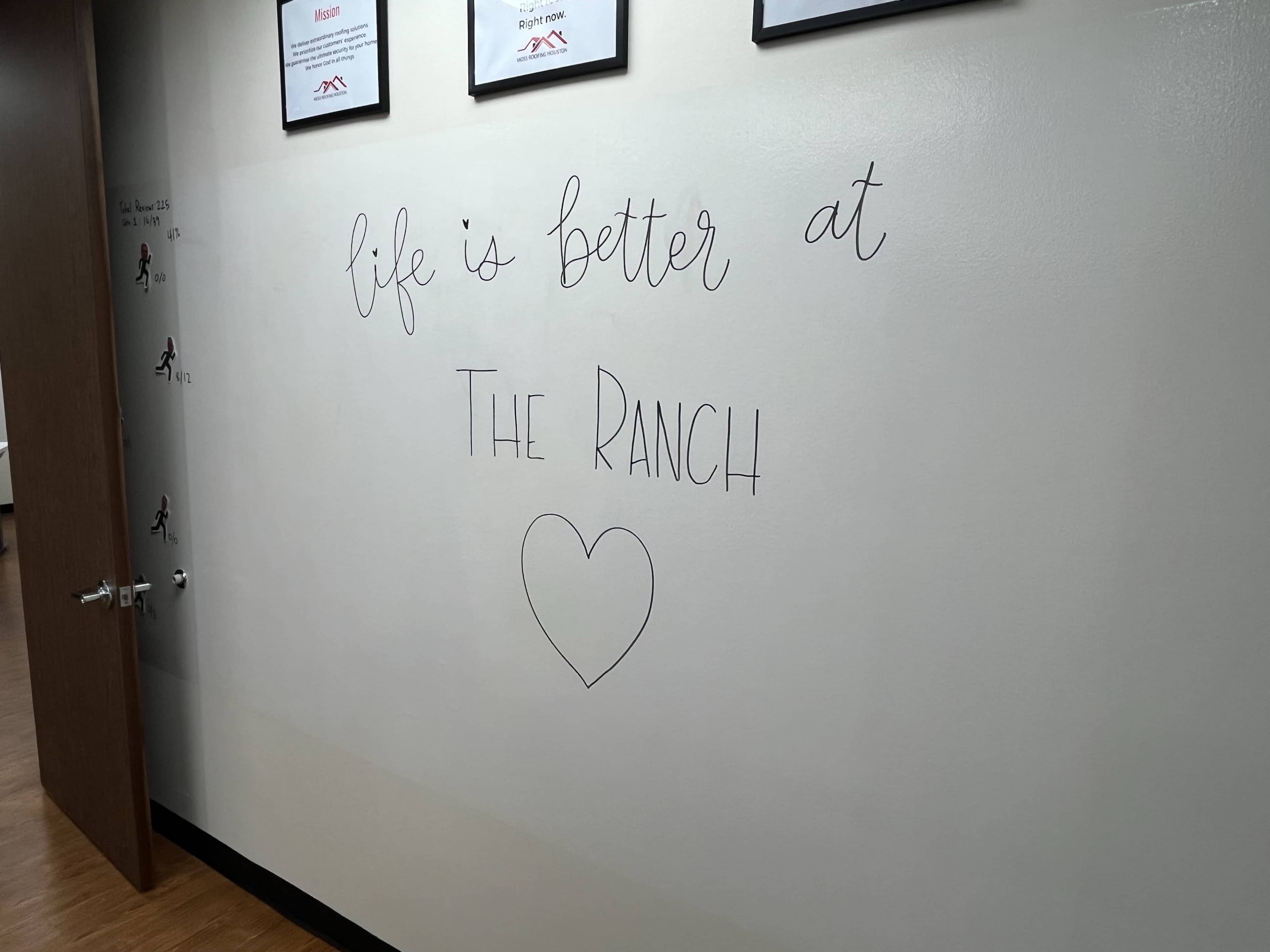The image shows a wall with the handwritten phrase "life is better at The Ranch" along with a heart symbol.