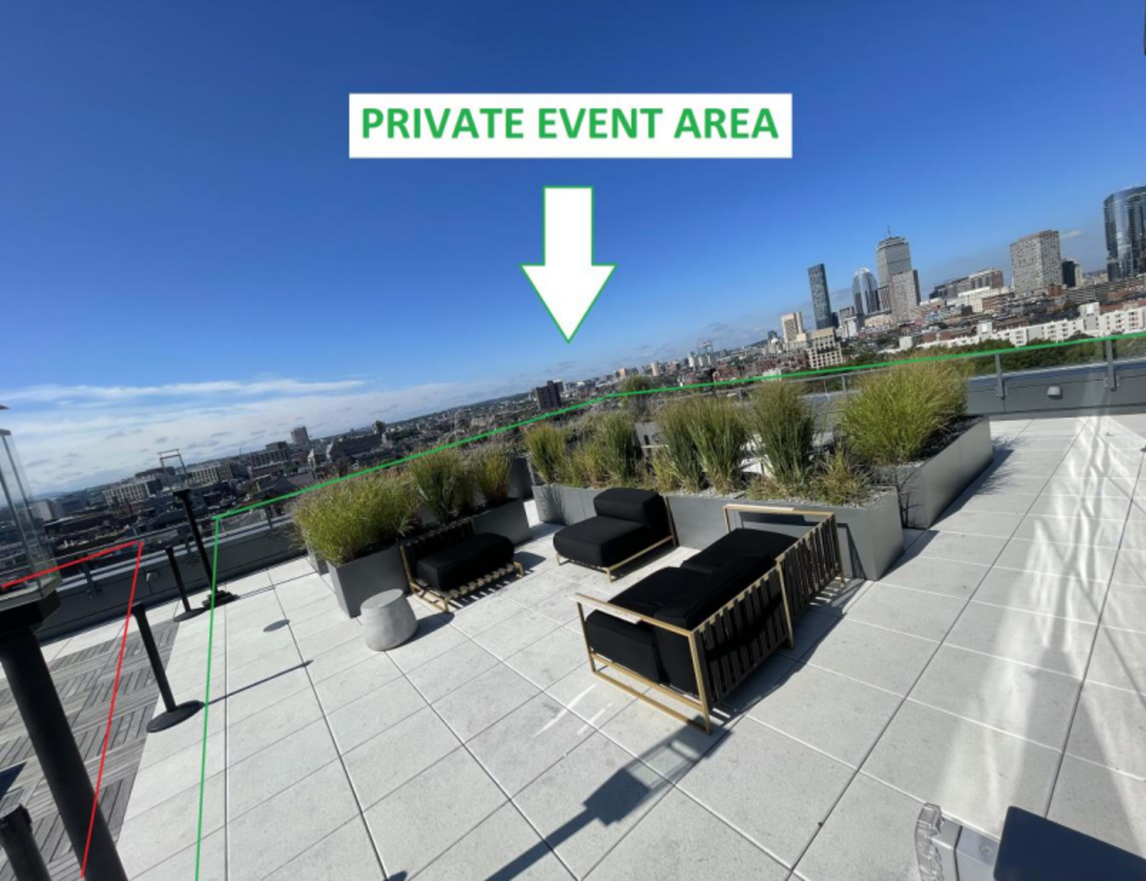 A rooftop space with seating arrangements, planters, and a sign indicating a private event area.