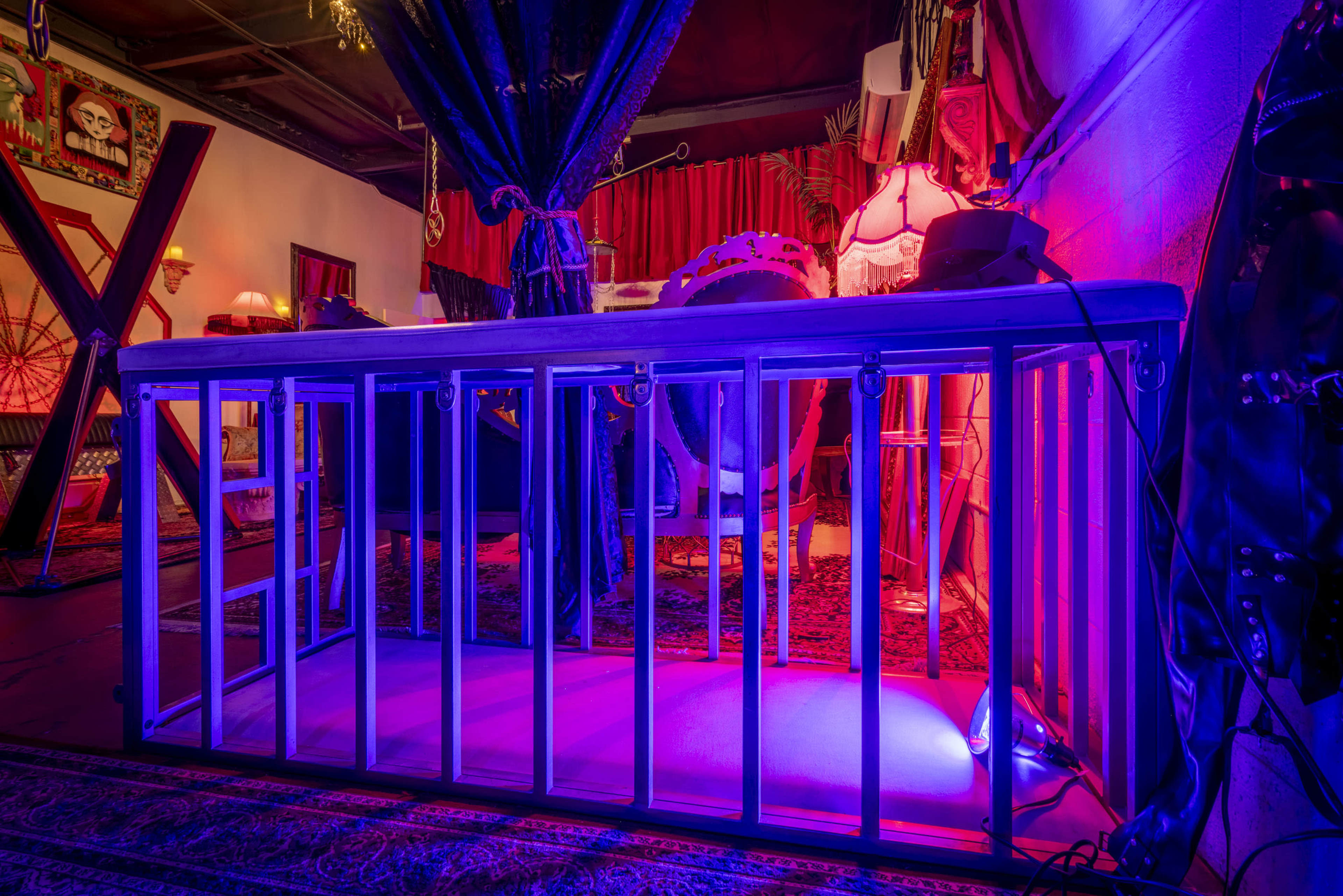 The image shows a wooden barricade in a dimly lit room adorned with various decorative elements and colored lighting.
