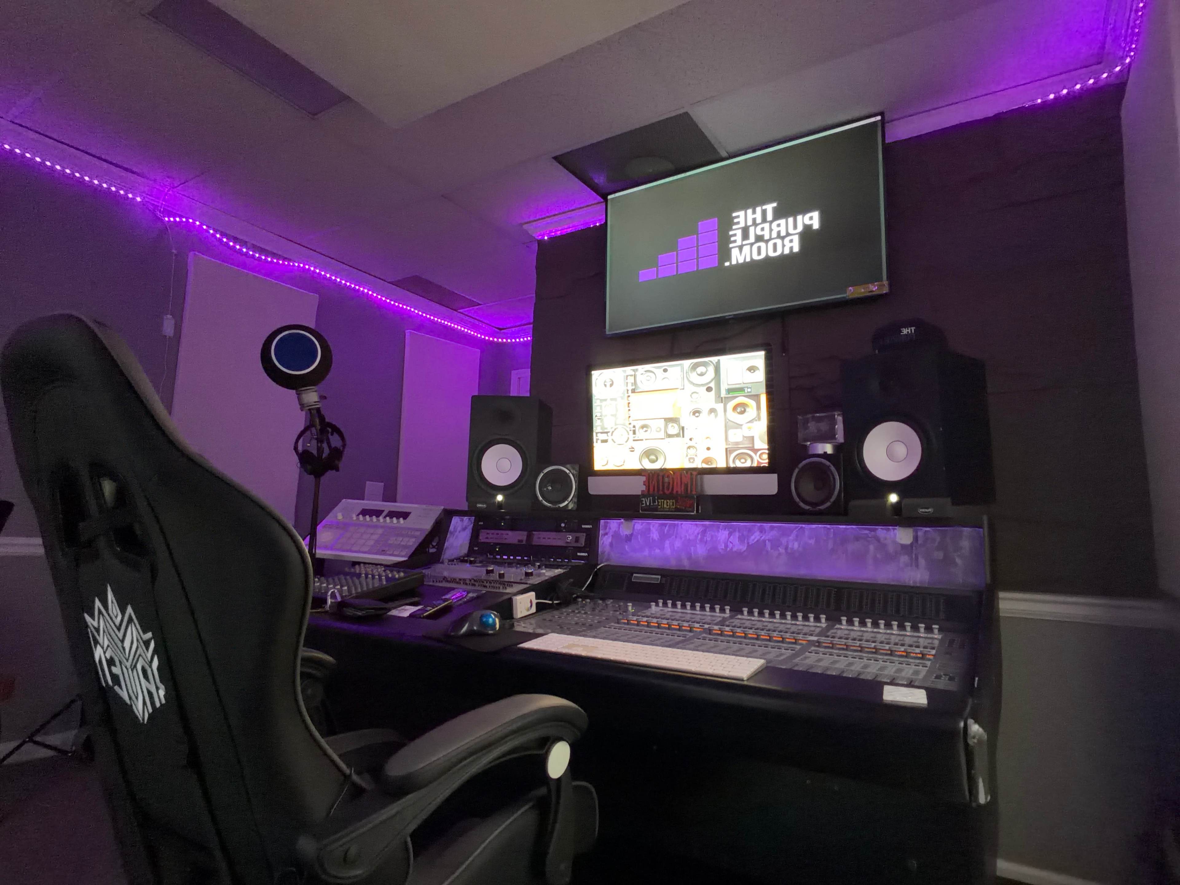 The image shows a music studio with a large mixing console, speakers, a microphone, and purple LED lighting.