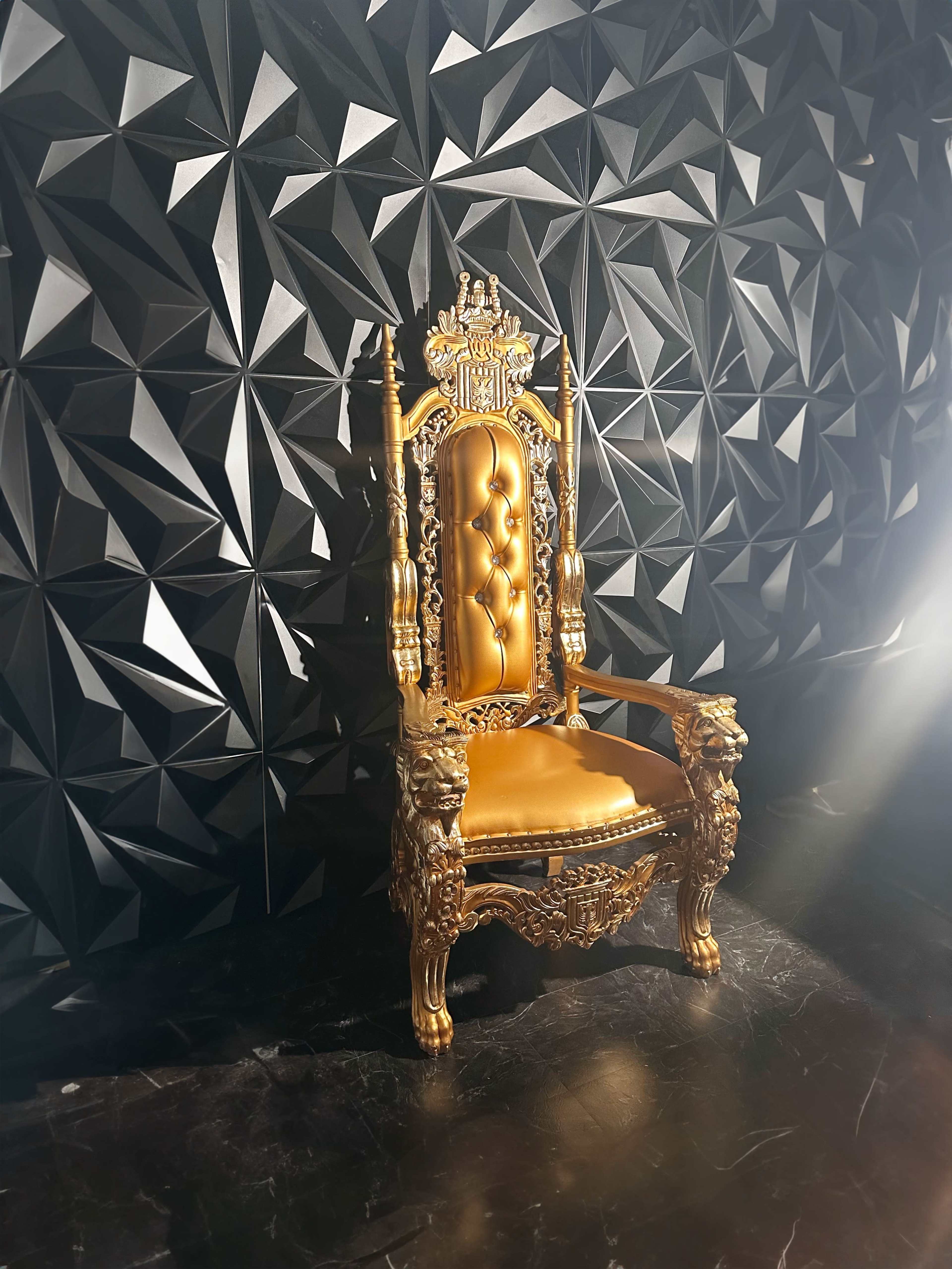 A gilded, ornate throne with lion motifs sits against a textured black wall featuring a geometric design.