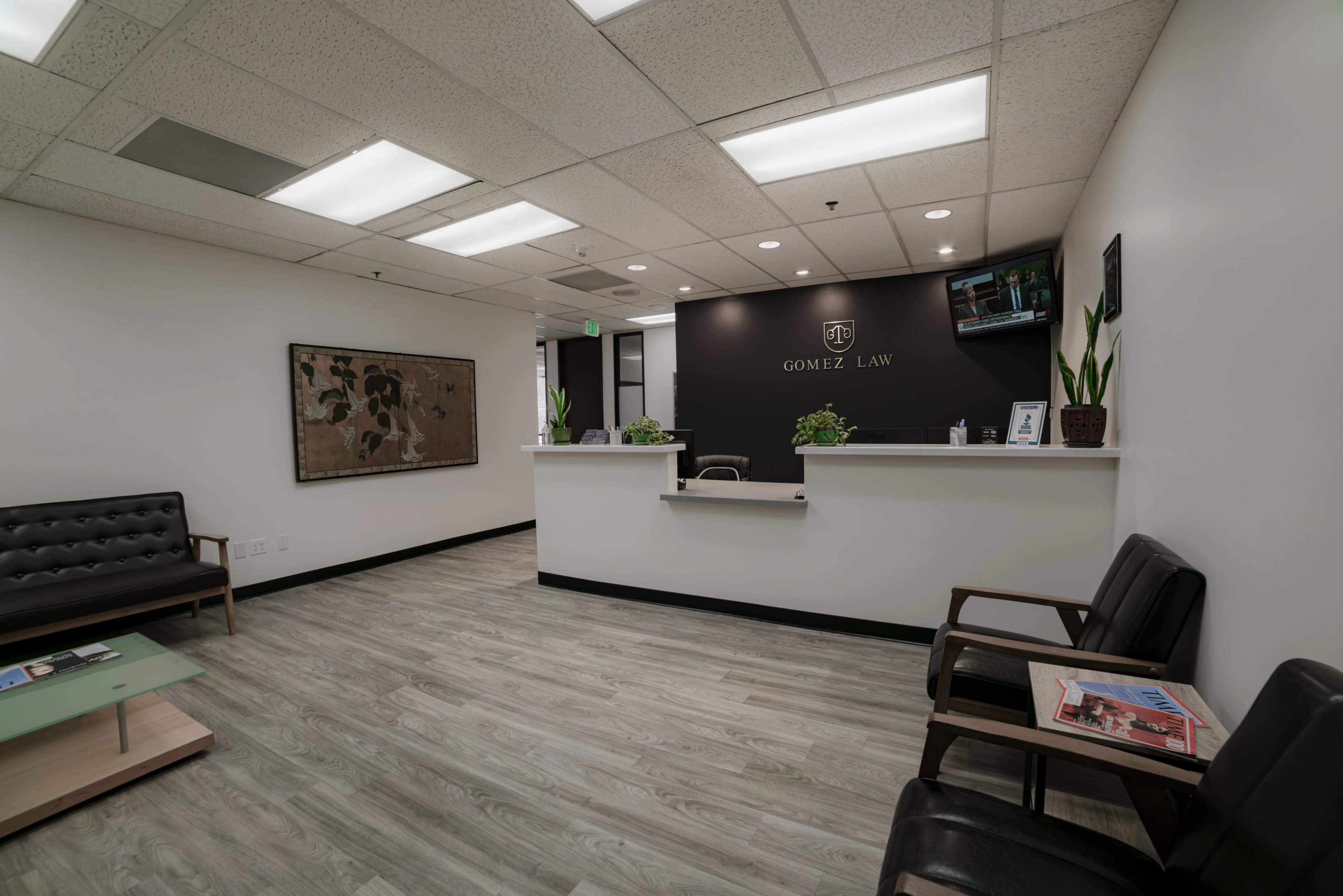 A law office reception area with a desk, seating for clients, and modern decor.