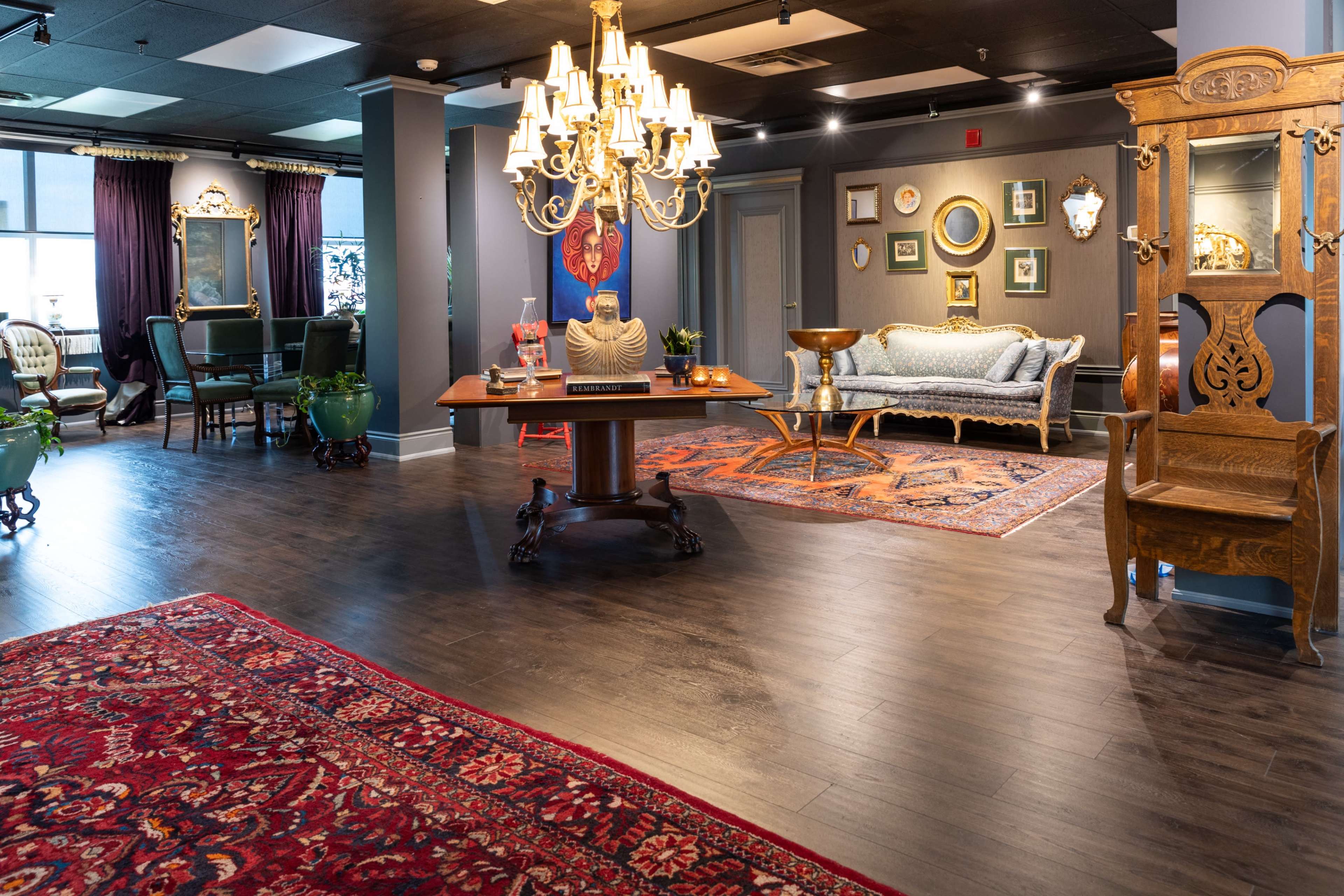 The image depicts a spacious interior of a decor store featuring elegant furniture, ornate lighting fixtures, and decorative rugs.