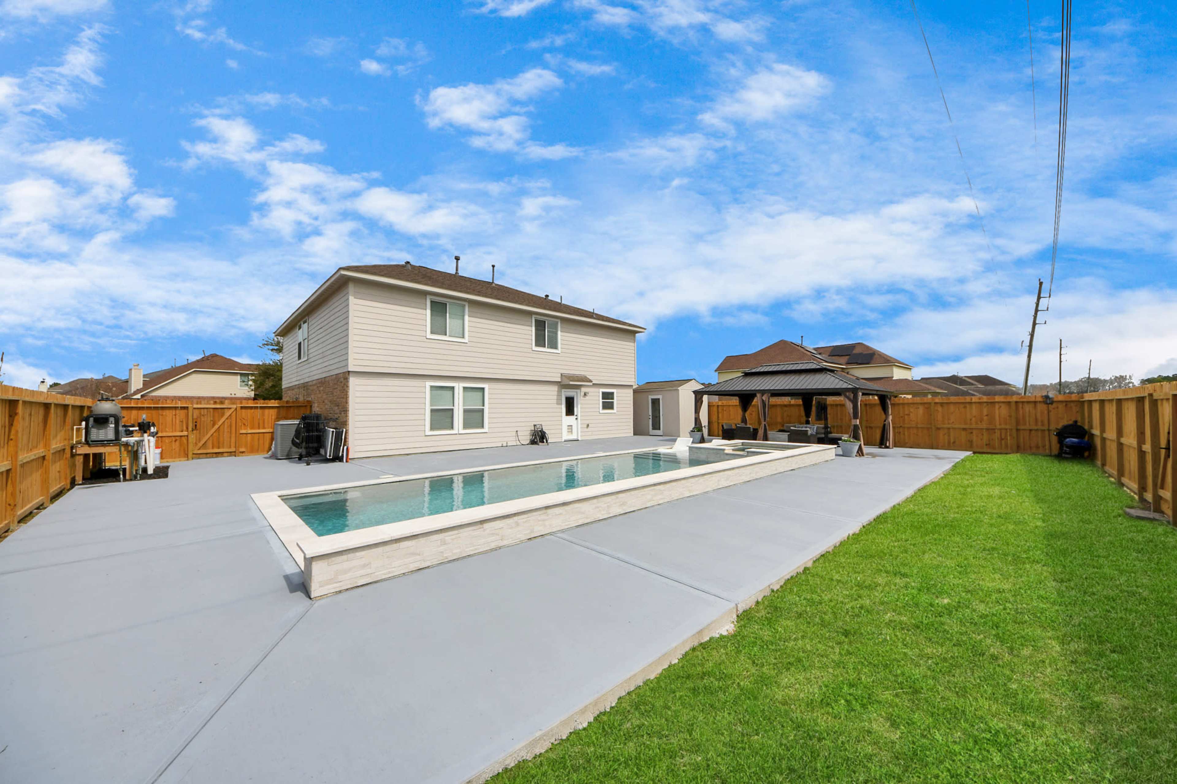 Near IAH airport spacious backyard with pool and firepit for celebrations and parties to memorable movie nights with family! Image in Humble, Humble, TX