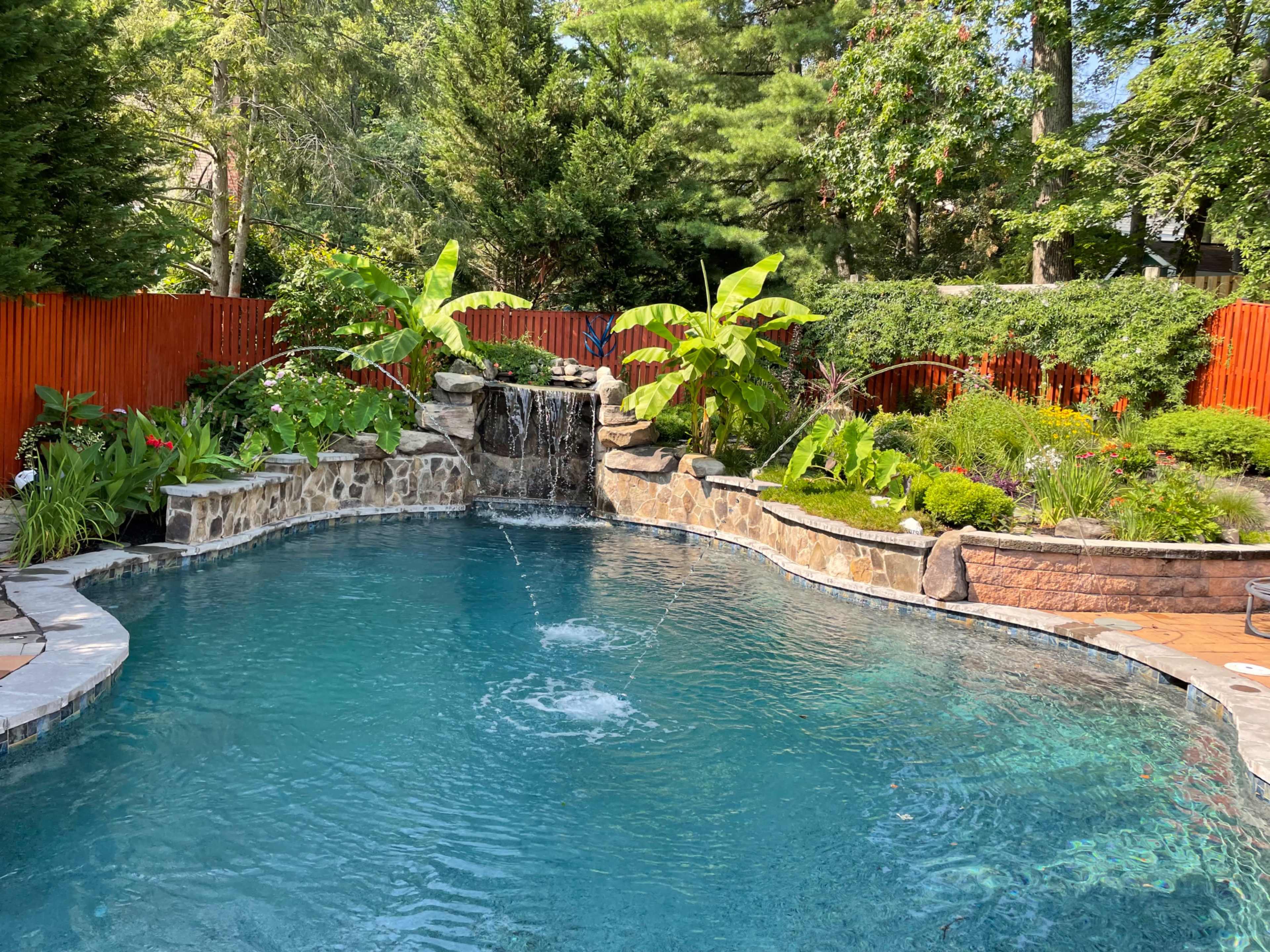 Pool with grotto surrounded by  tropical gardens Image in Savage, Savage, MD