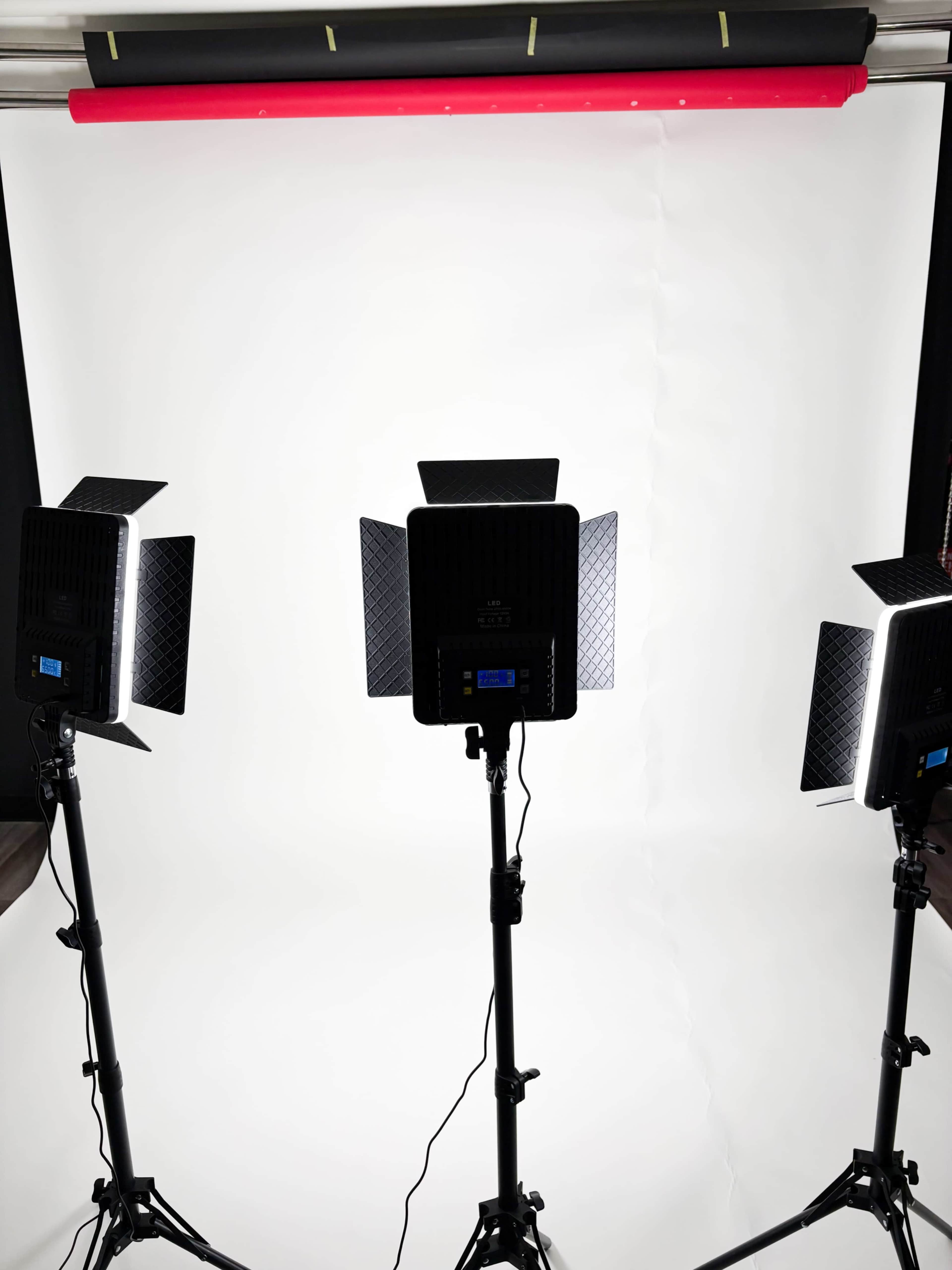 The image shows three lighting setups positioned in front of a plain white backdrop.