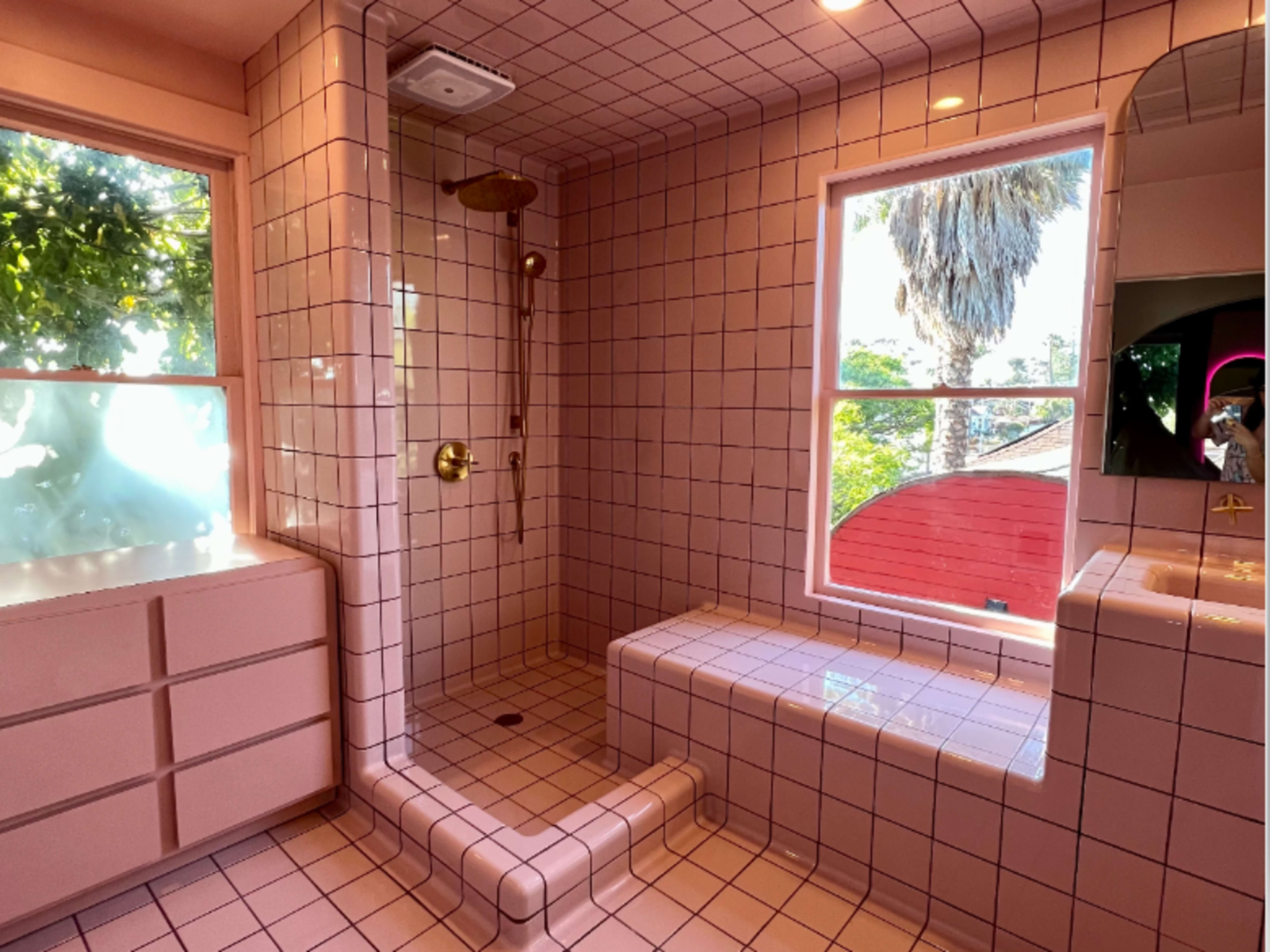 Access to the pink tiled bathroom