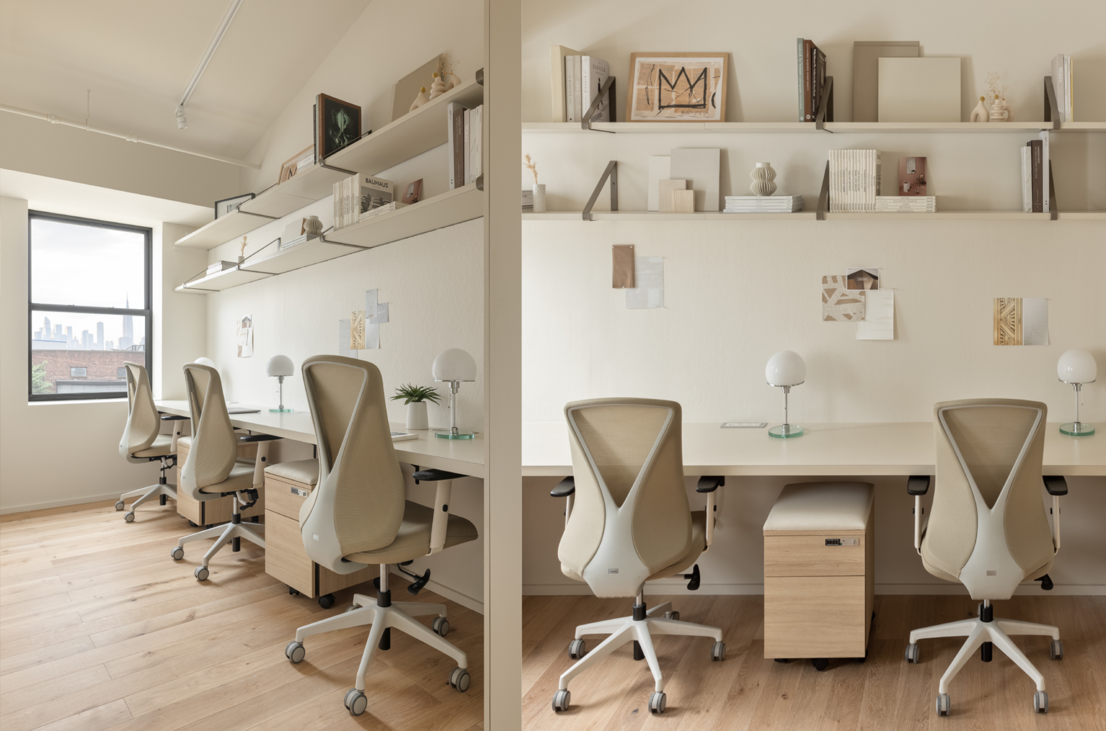 The image shows a modern office space with two sets of white desks, ergonomic chairs, and shelves filled with books and decorative items, overlooking a city skyline through large windows.