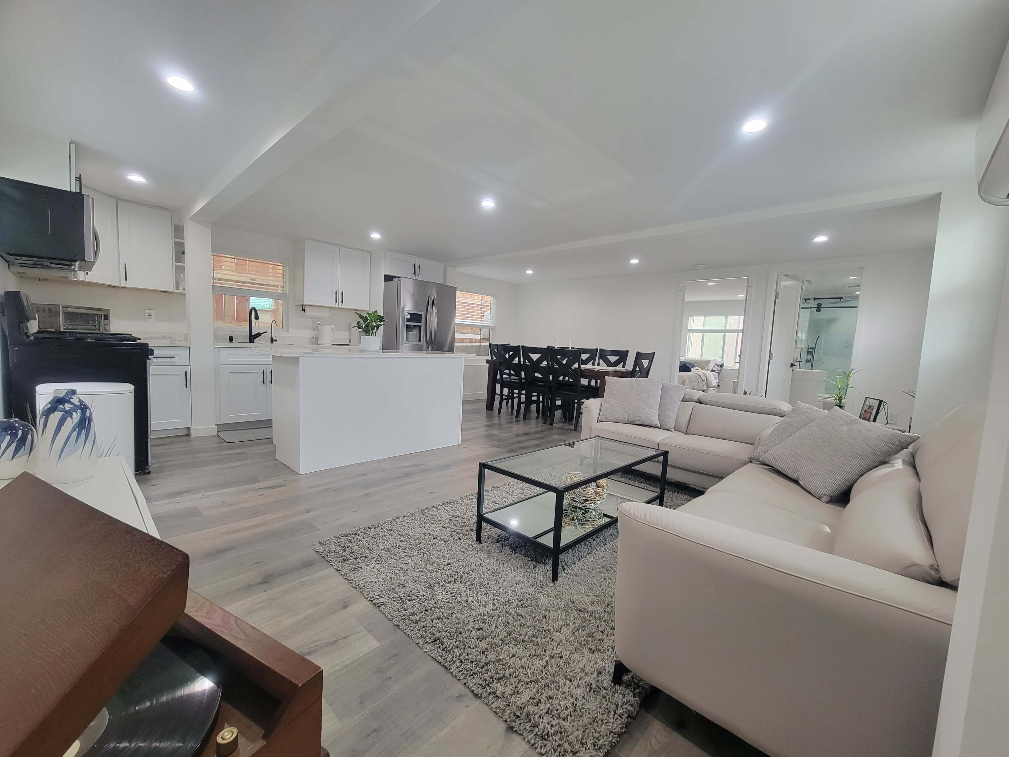 A modern open-concept living area featuring a kitchen, dining space, and comfortable seating arrangement.