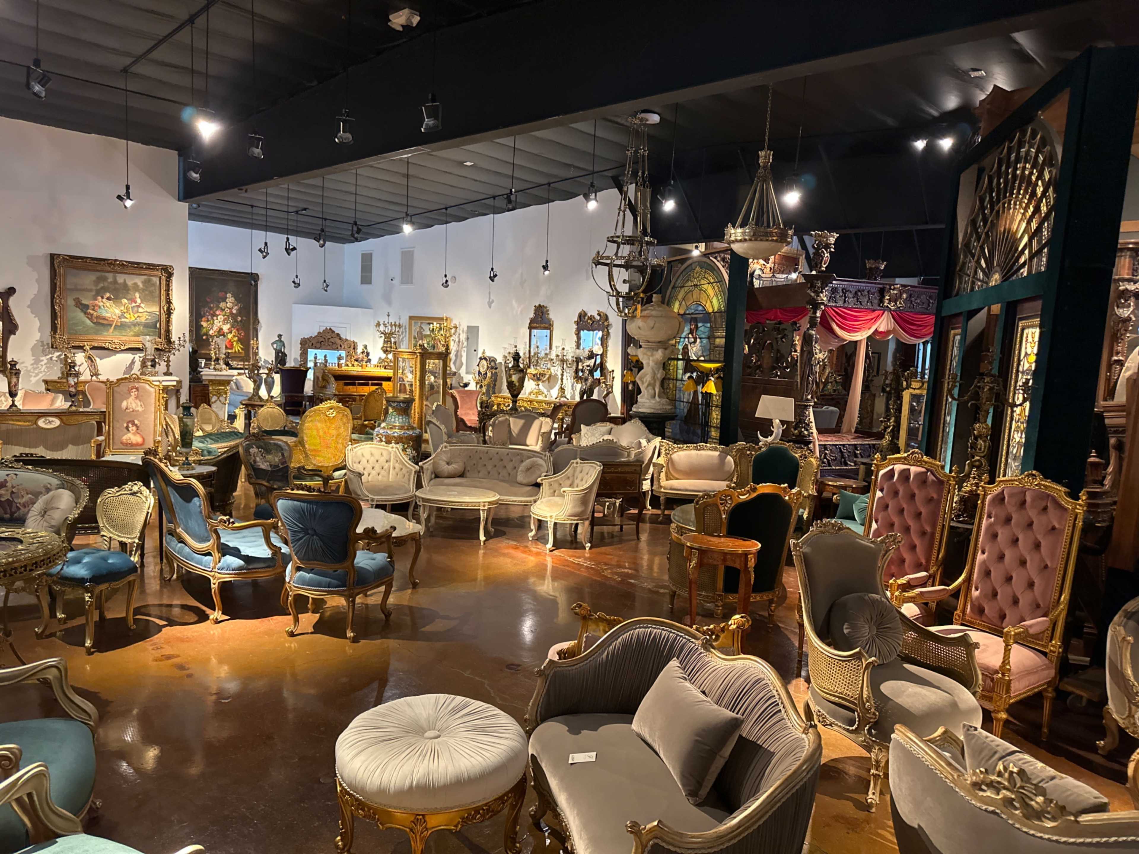 A spacious furniture showroom filled with various ornate chairs and seating arrangements.