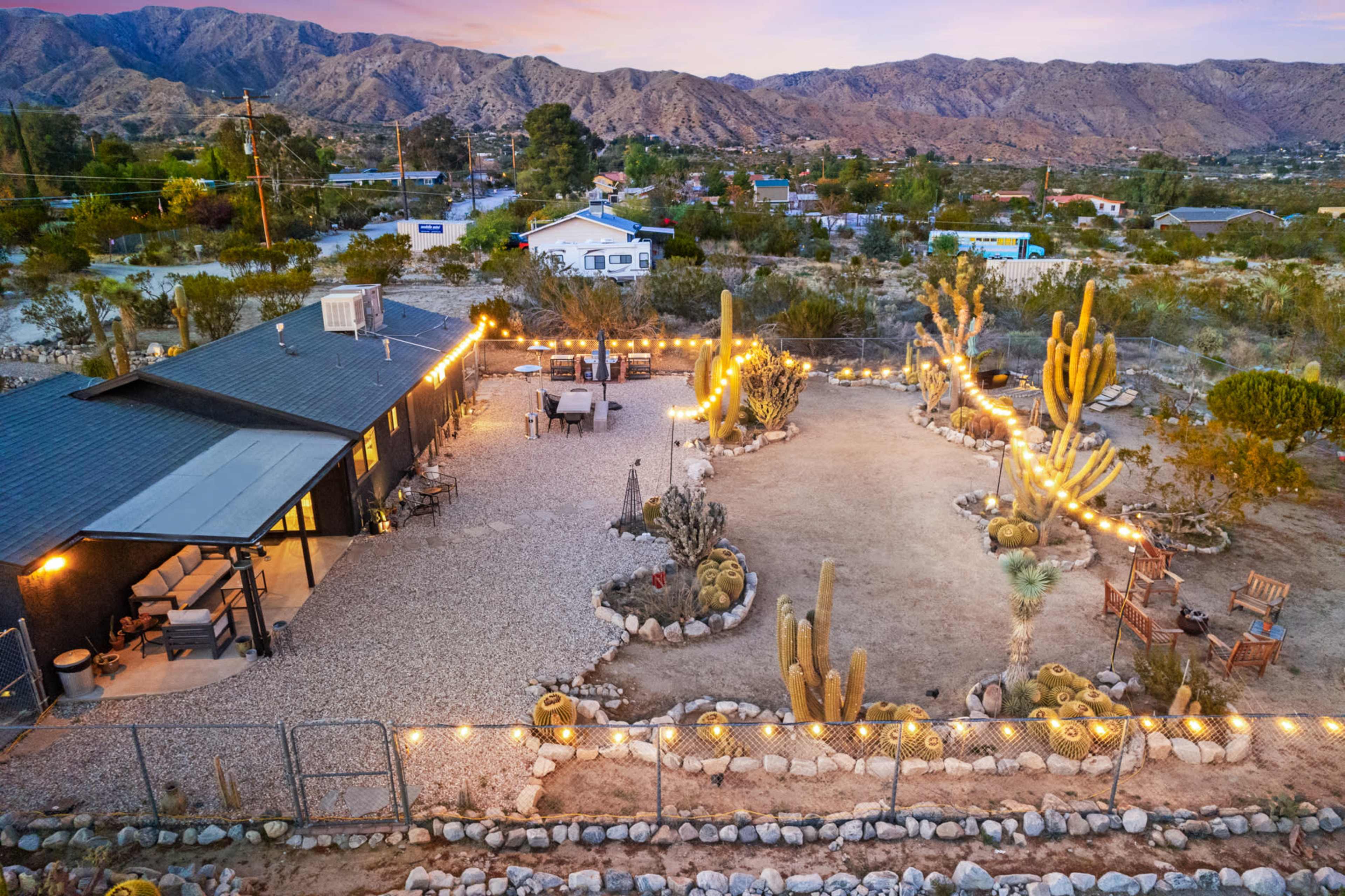 A desert home sitting in a cactus-filled botanical garden Image in , MORONGO VALLEY, CA