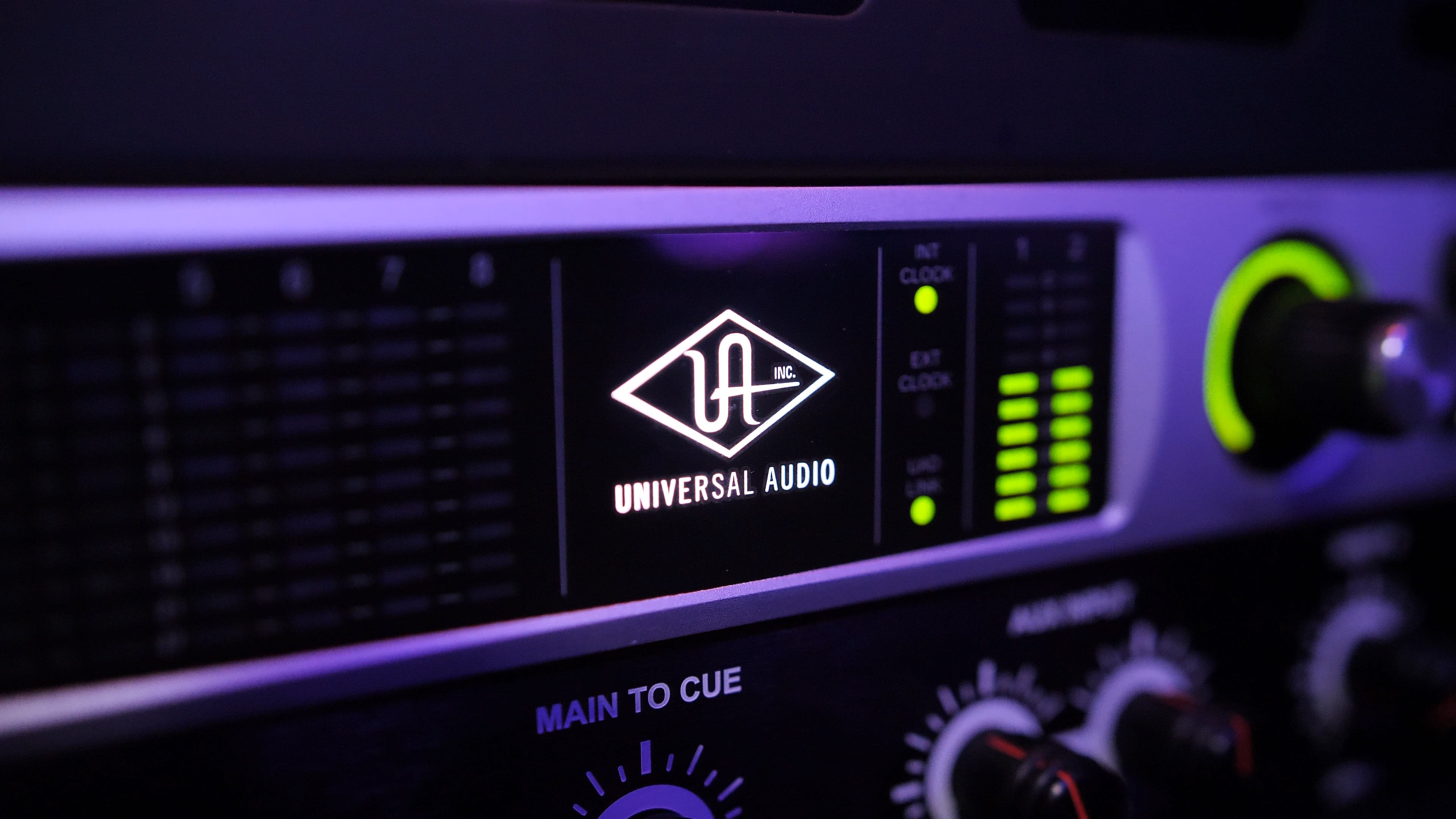 A close-up of a Universal Audio device, featuring its logo and various control knobs and indicators.