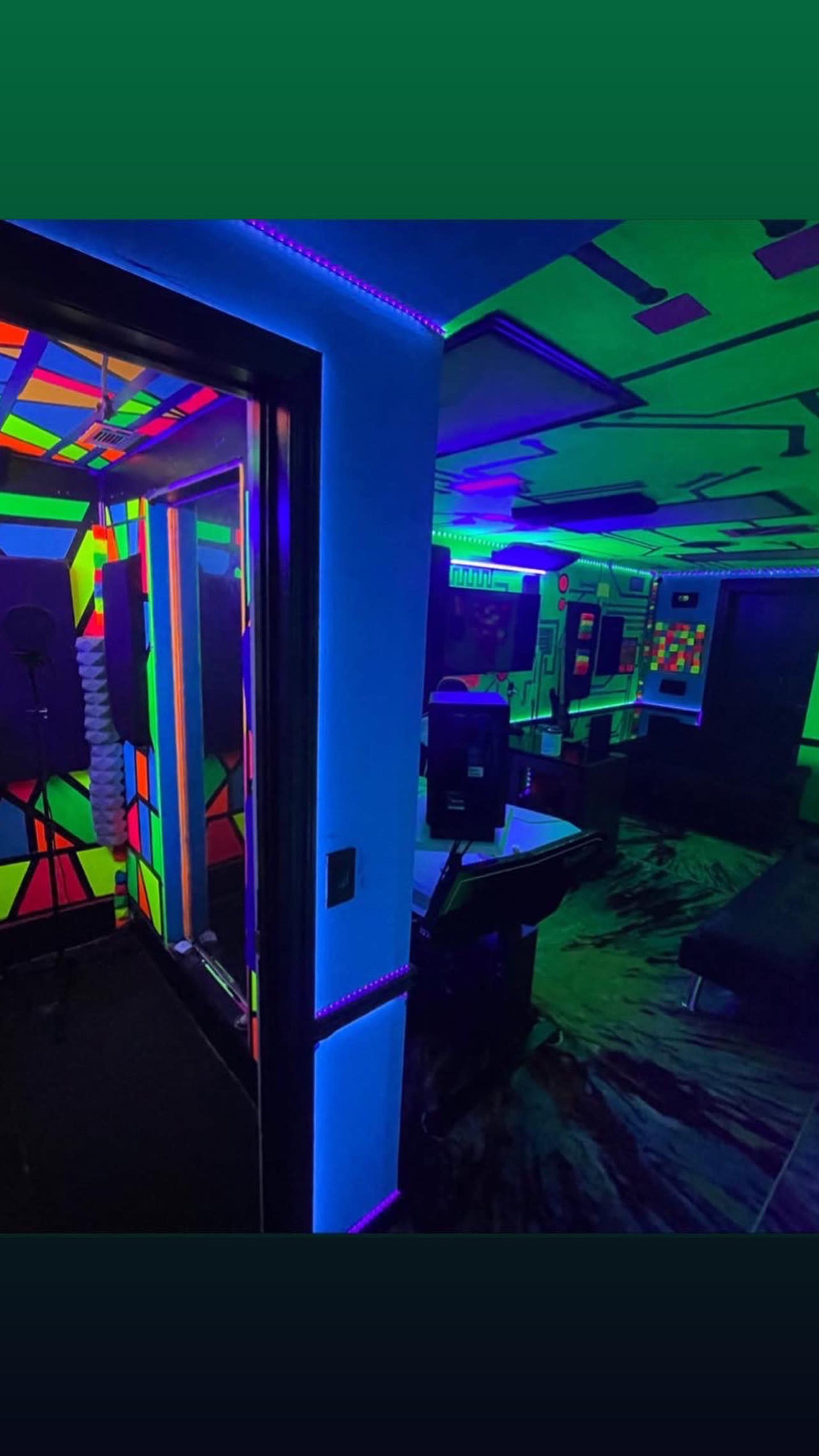 The scene features a vibrant, neon-lit room with a recording booth, a pool table, and walls decorated in bold geometric patterns.