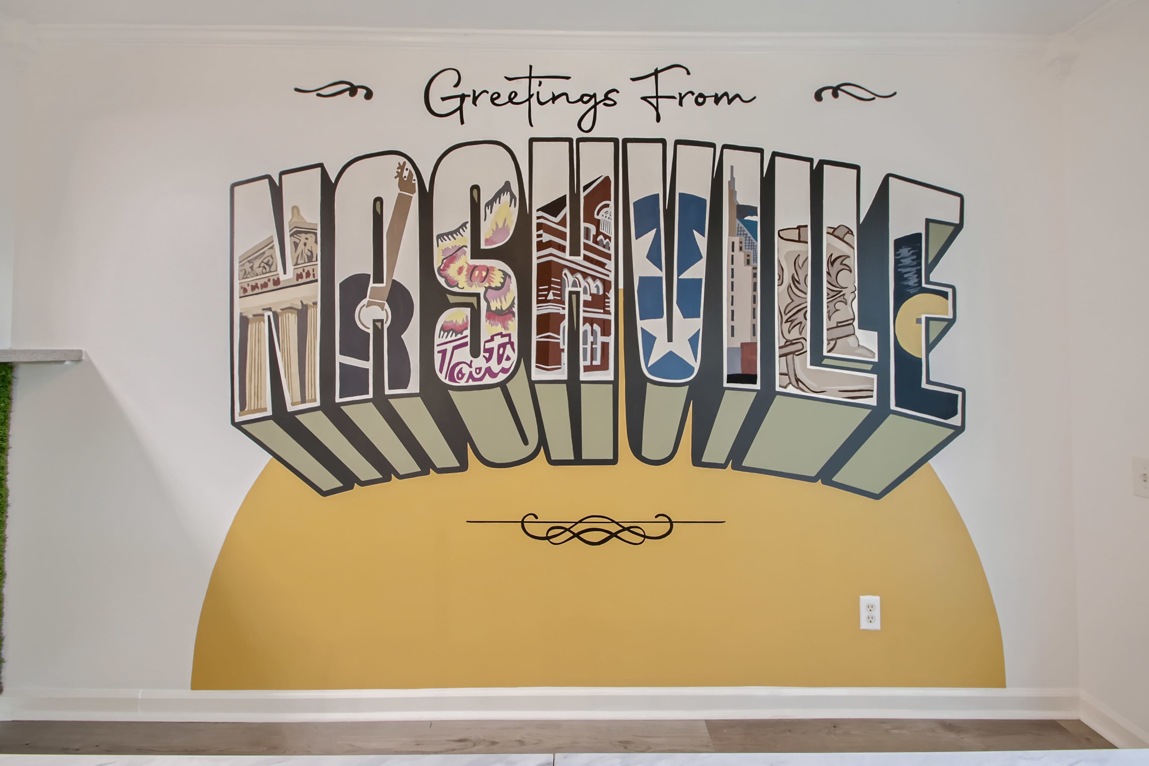 A colorful mural on a wall that reads "Greetings From Nashville" in large, stylized letters.