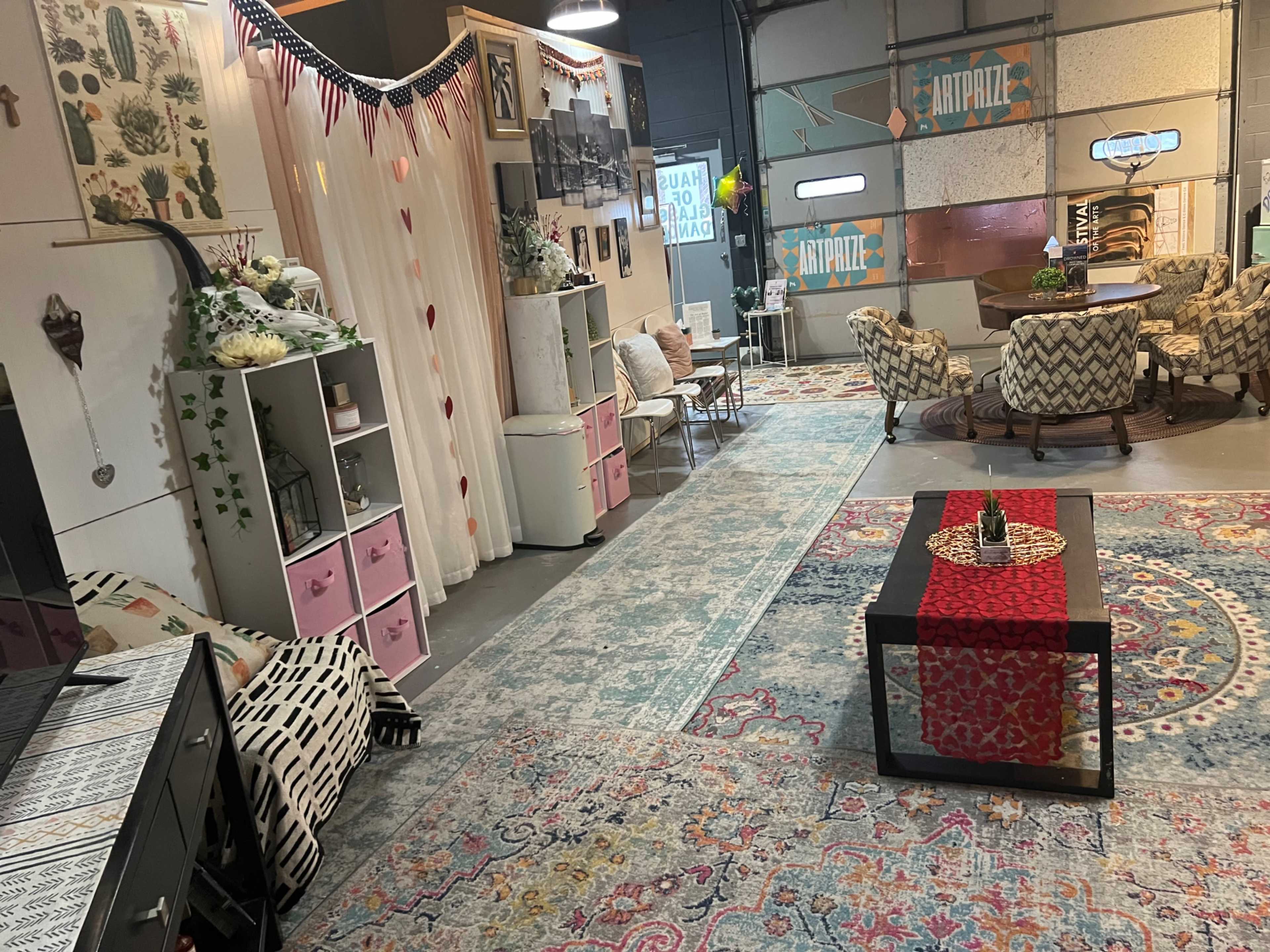 A cozy interior space with patterned rugs, a seating area, and decorative furnishings arranged in a stylish layout.