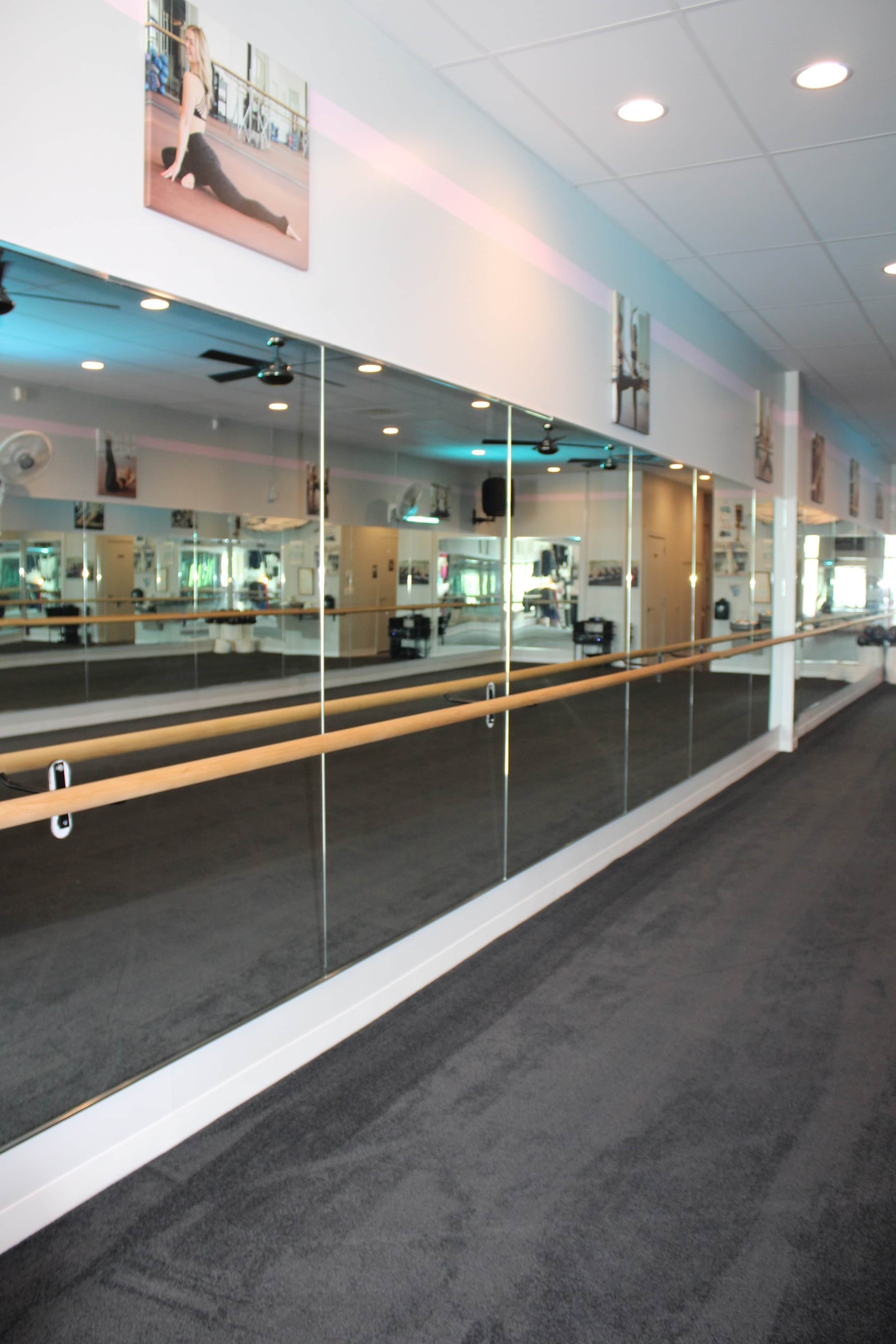 Urban area, open carpeted studio space for fitness, movement, dance, stretching, and more, comfortable and homey yet open, studio space, lobby and office area. Image in Lawrence, Lawrence, KS