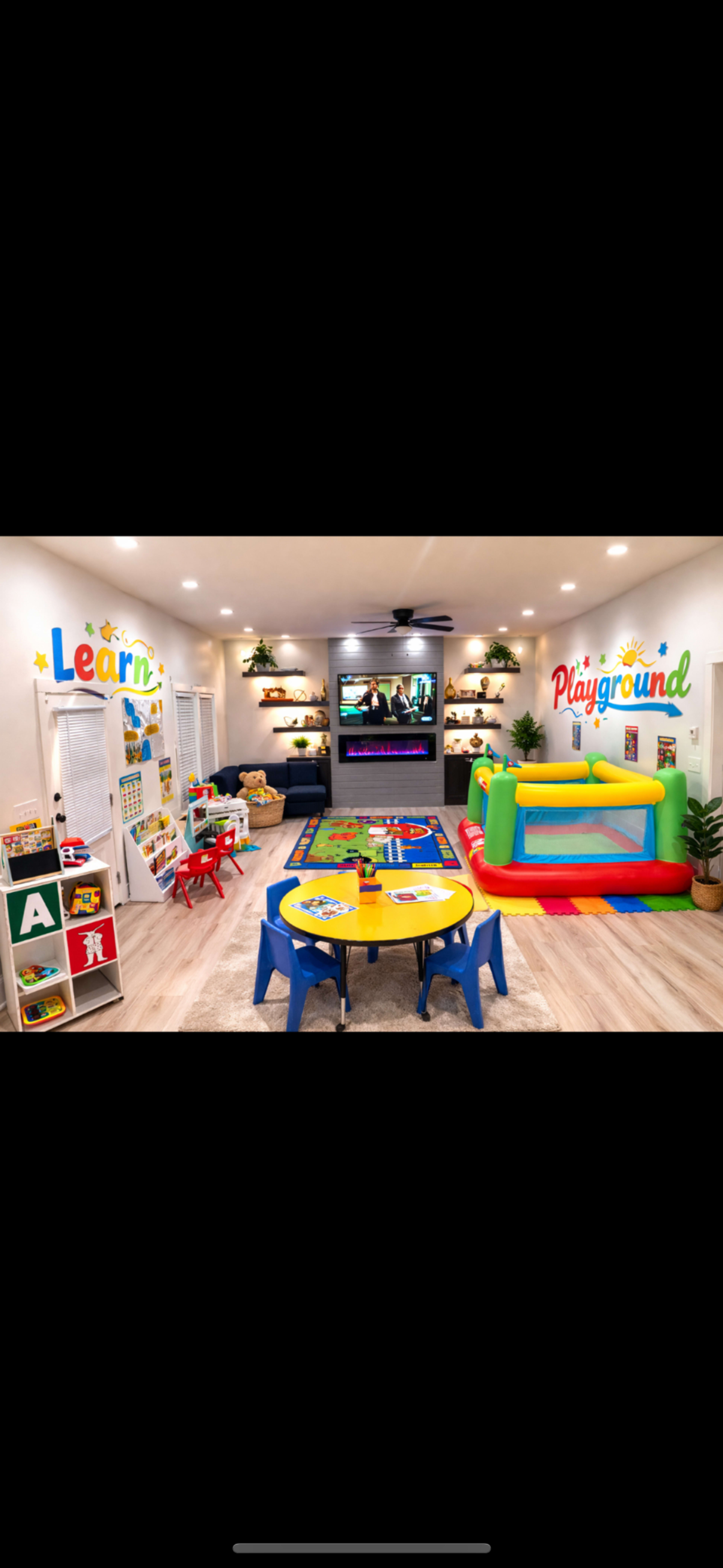 The room features a colorful play area with a bouncy castle, children’s tables, shelves filled with toys, and wall decor labeled “Learn” and “Playground.”