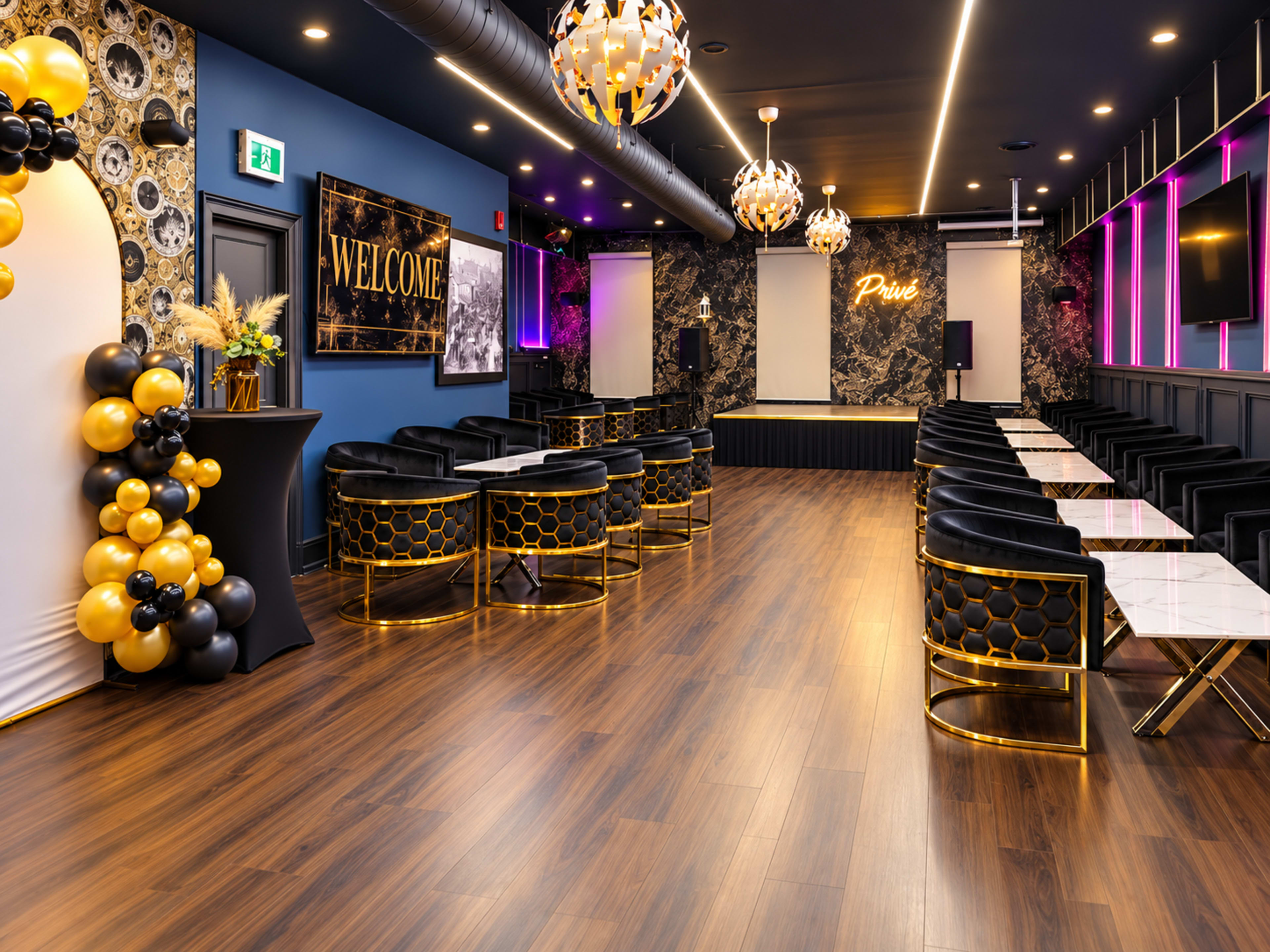 The image shows a modern event space featuring black and gold decor, seating arrangements, and a stage area with dramatic lighting.
