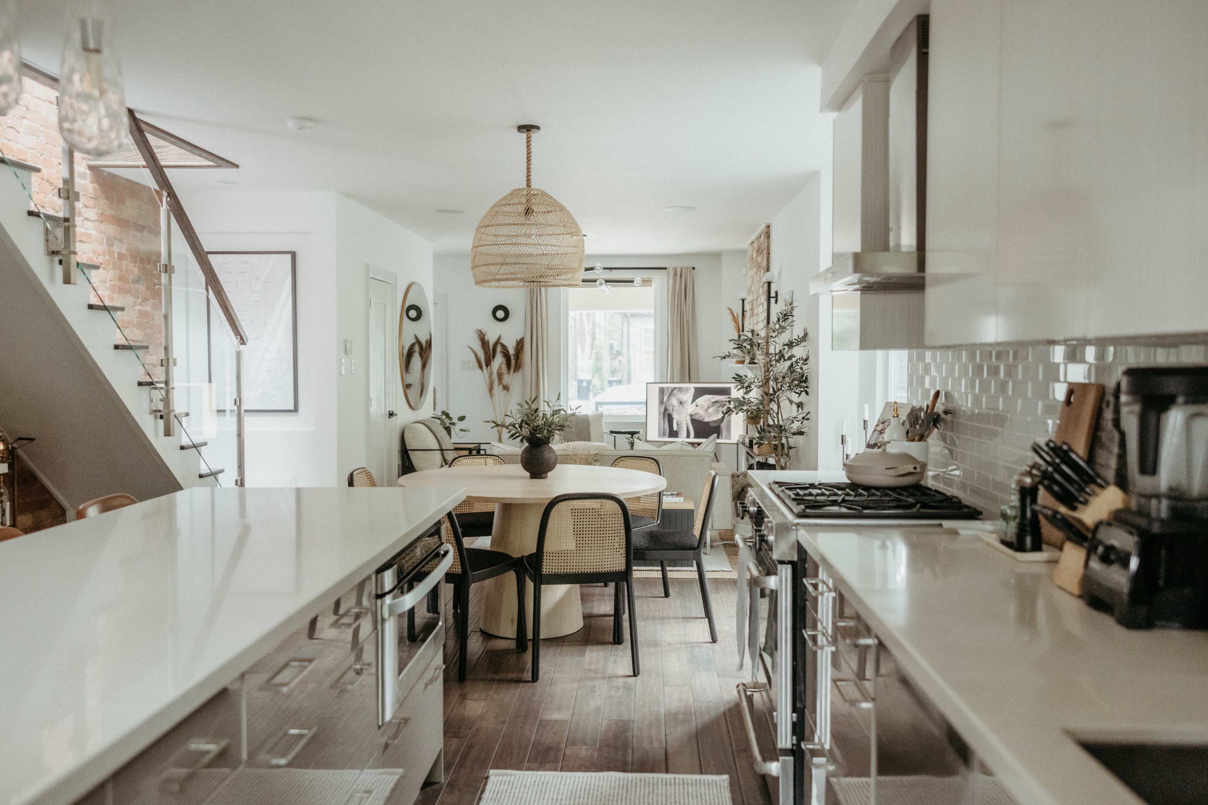 The kitchen features modern cabinetry, a spacious dining area, and large windows that provide natural light.