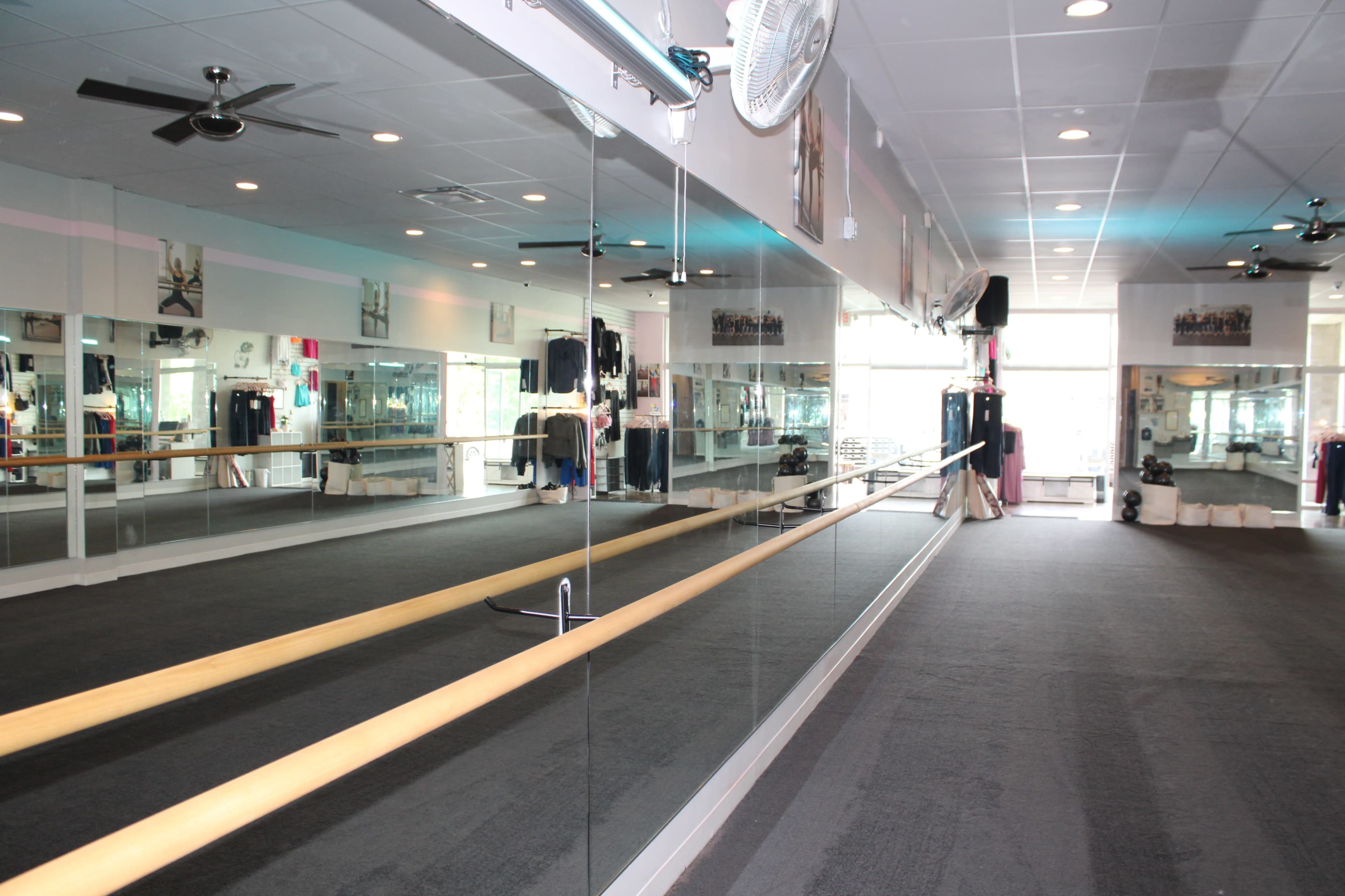 Urban area, open carpeted studio space for fitness, movement, dance, stretching, and more, comfortable and homey yet open, studio space, lobby and office area. Image in Lawrence, Lawrence, KS
