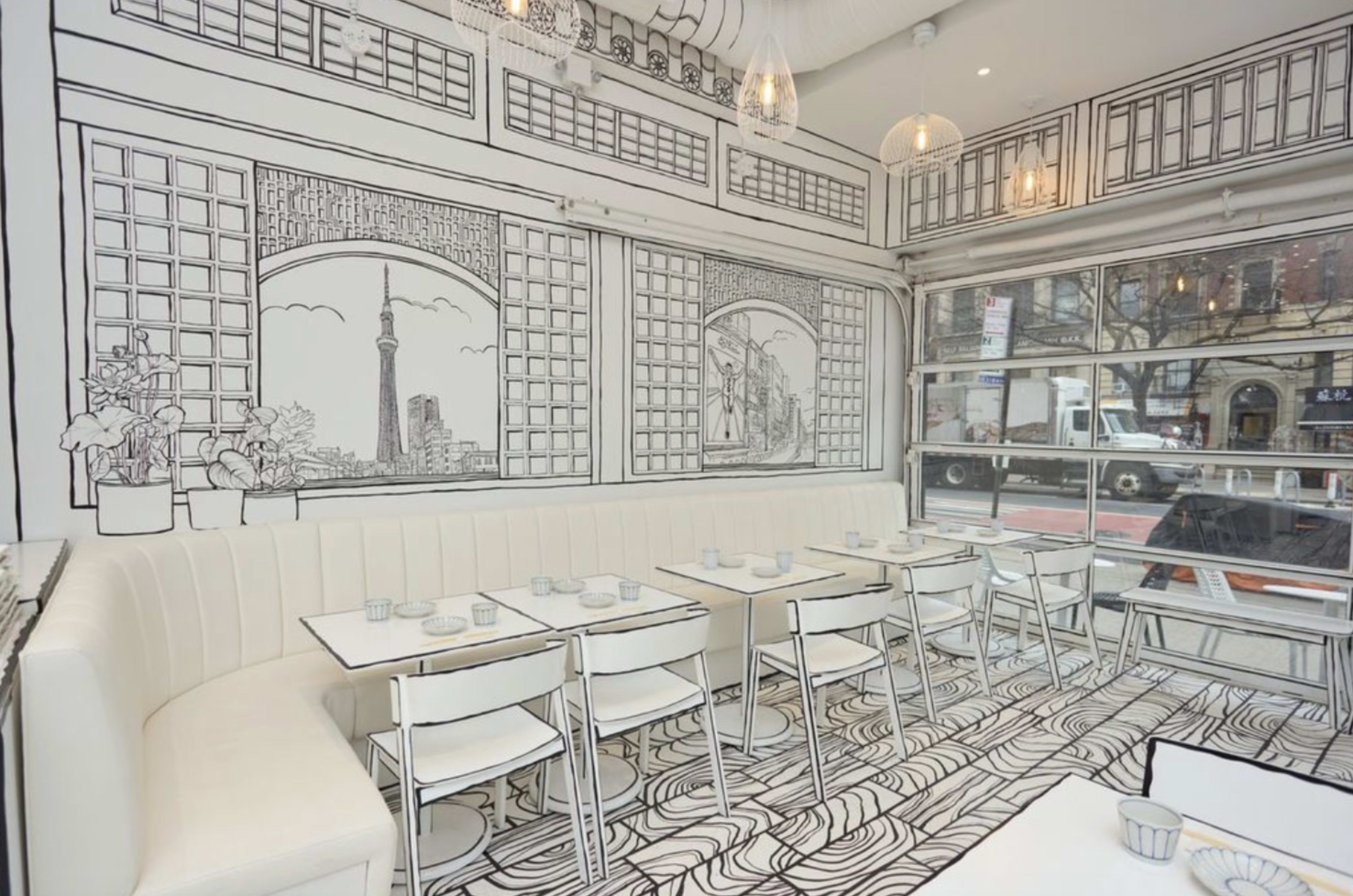 The image shows a white and black-themed restaurant interior featuring outlined views of cityscapes on the walls, tables, and flooring.