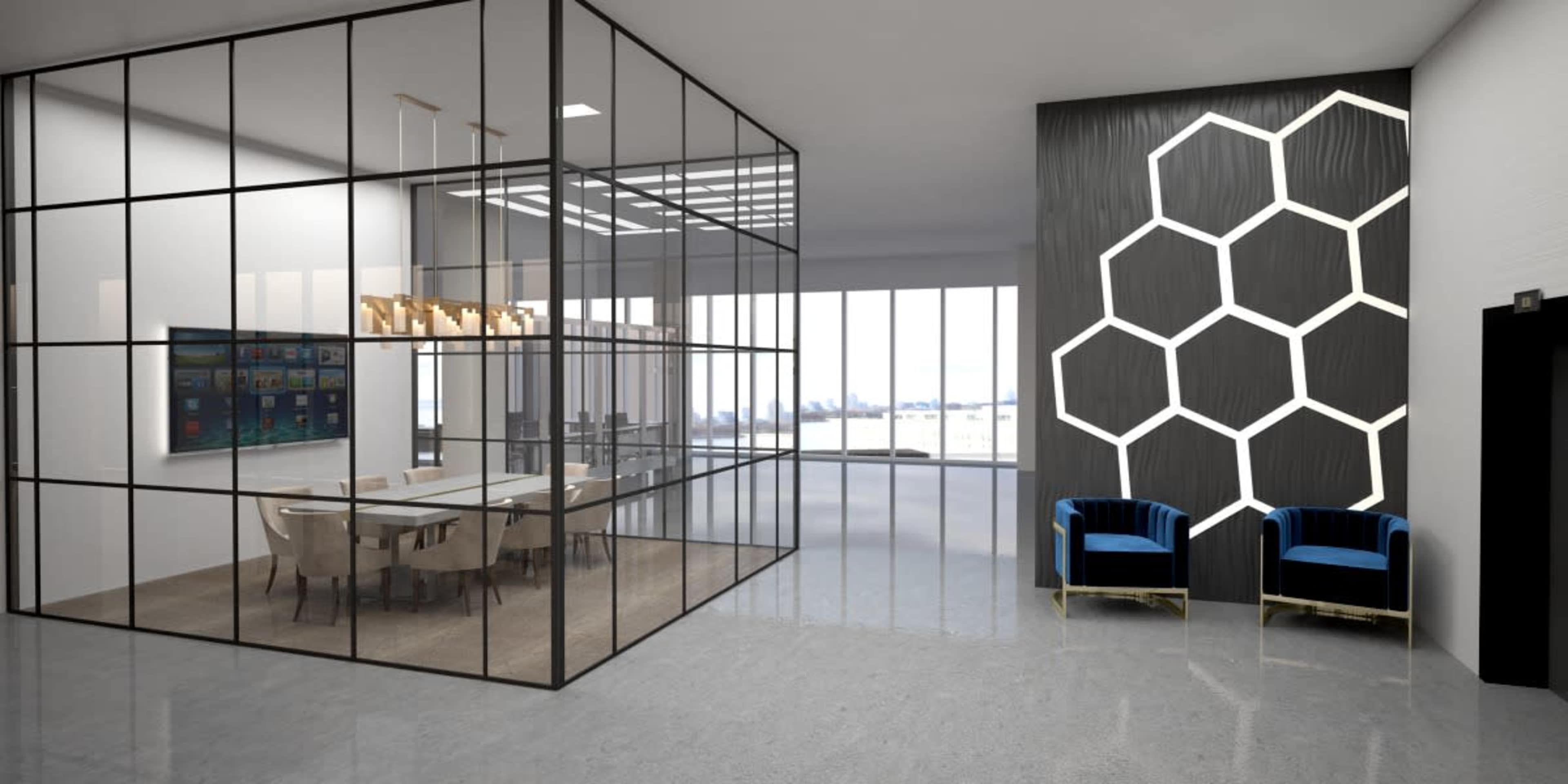 The image shows a modern office space featuring a glass-walled conference room, a sleek media wall, and two blue armchairs against a geometric patterned accent wall.